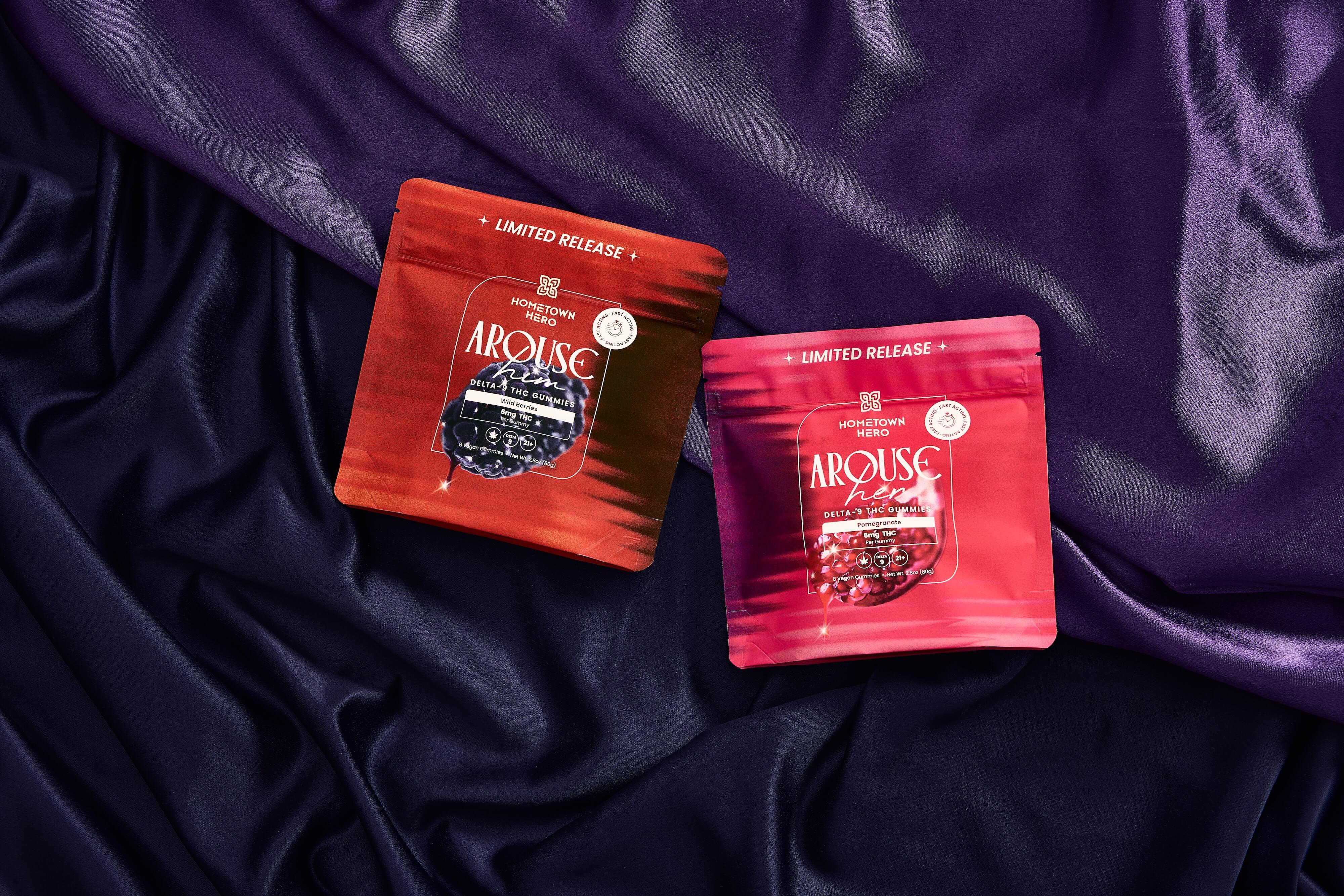 two bags of pink and red gummies on a silk purple sheet