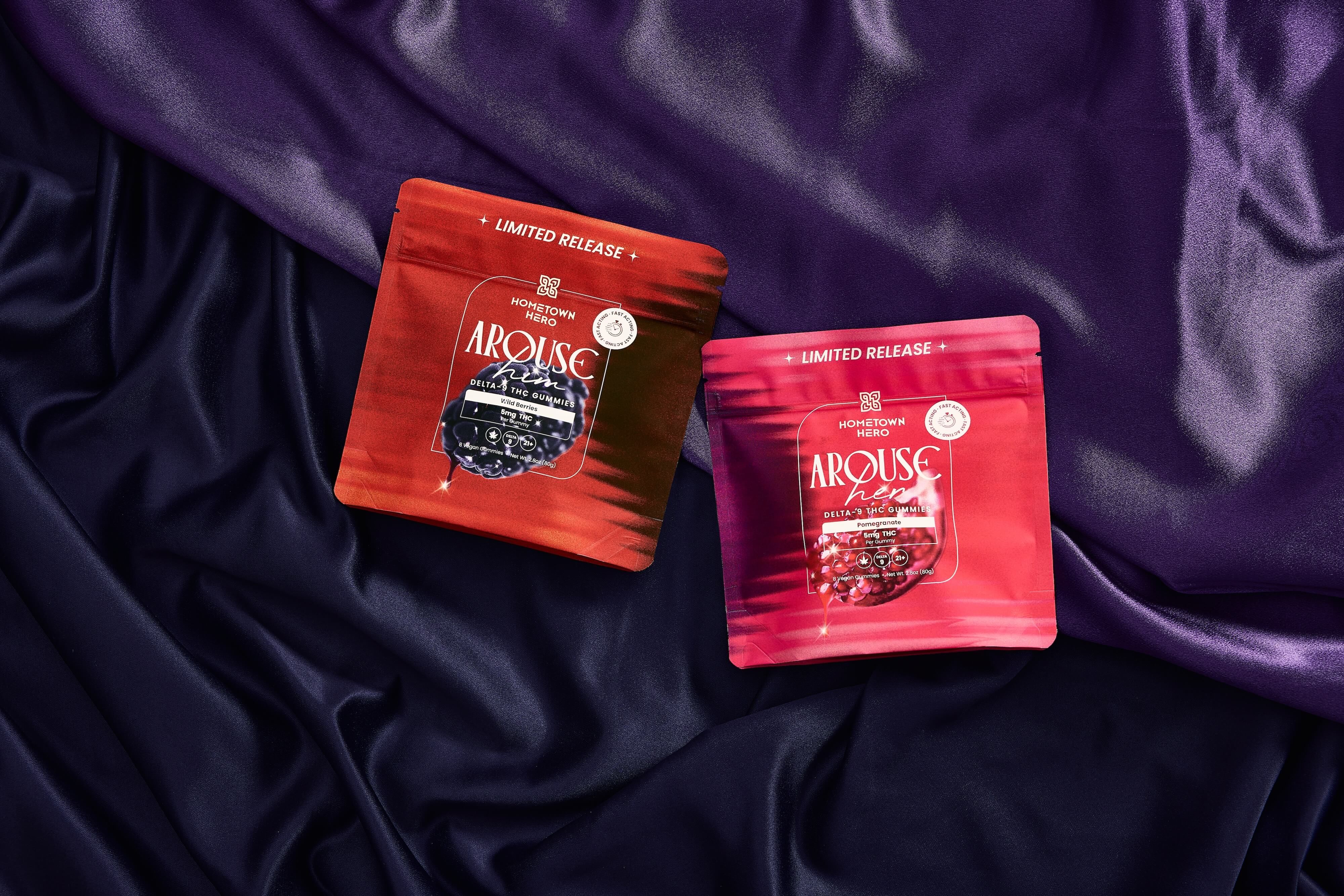 two bags of pink and red gummies on a silk purple sheet
