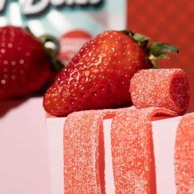 Strawberry Sour Belts candies and strawberry