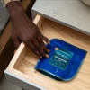 Hand reaching out for bag of gummies in bedside table