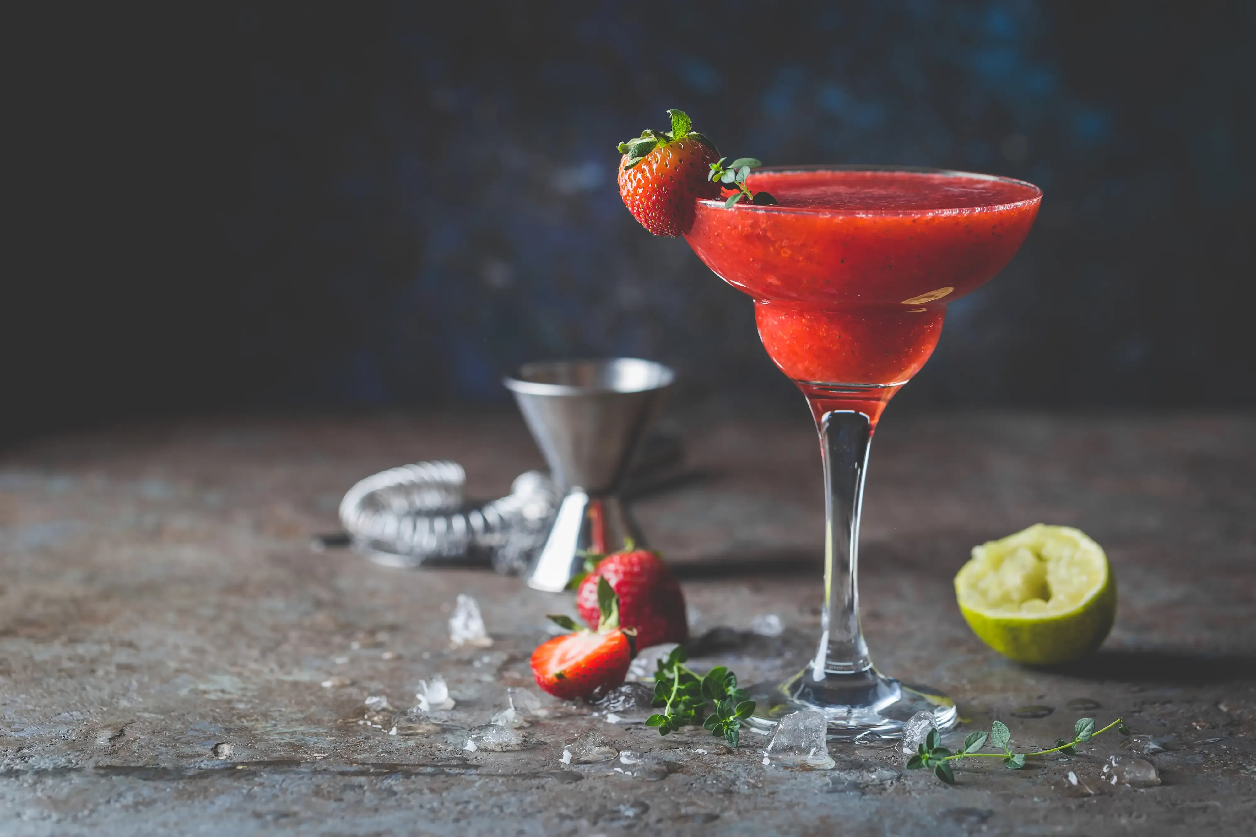 Ice Strawberry alcohol cocktail with lime and rum in a glass