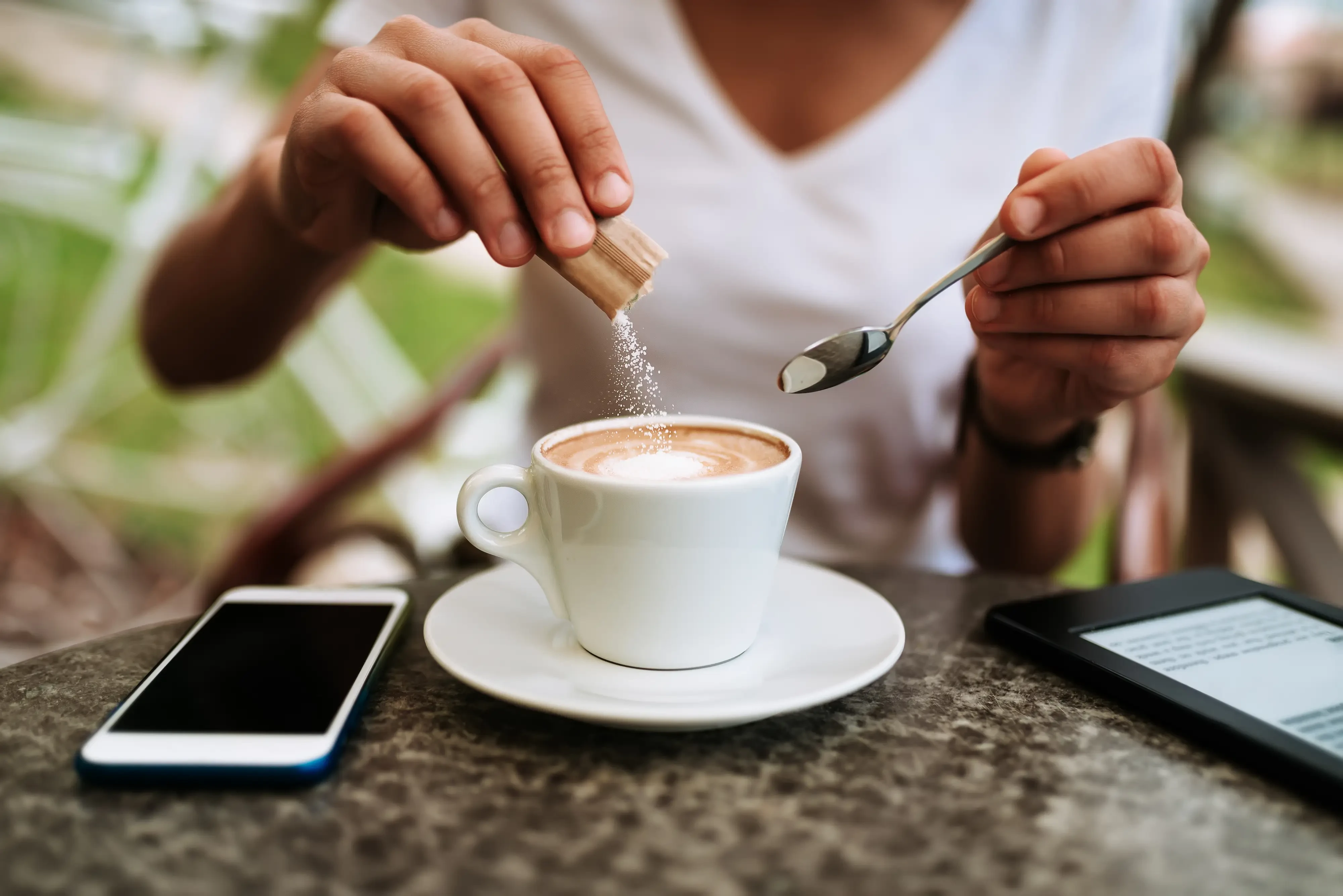 pouring allulose into a cappuccino
