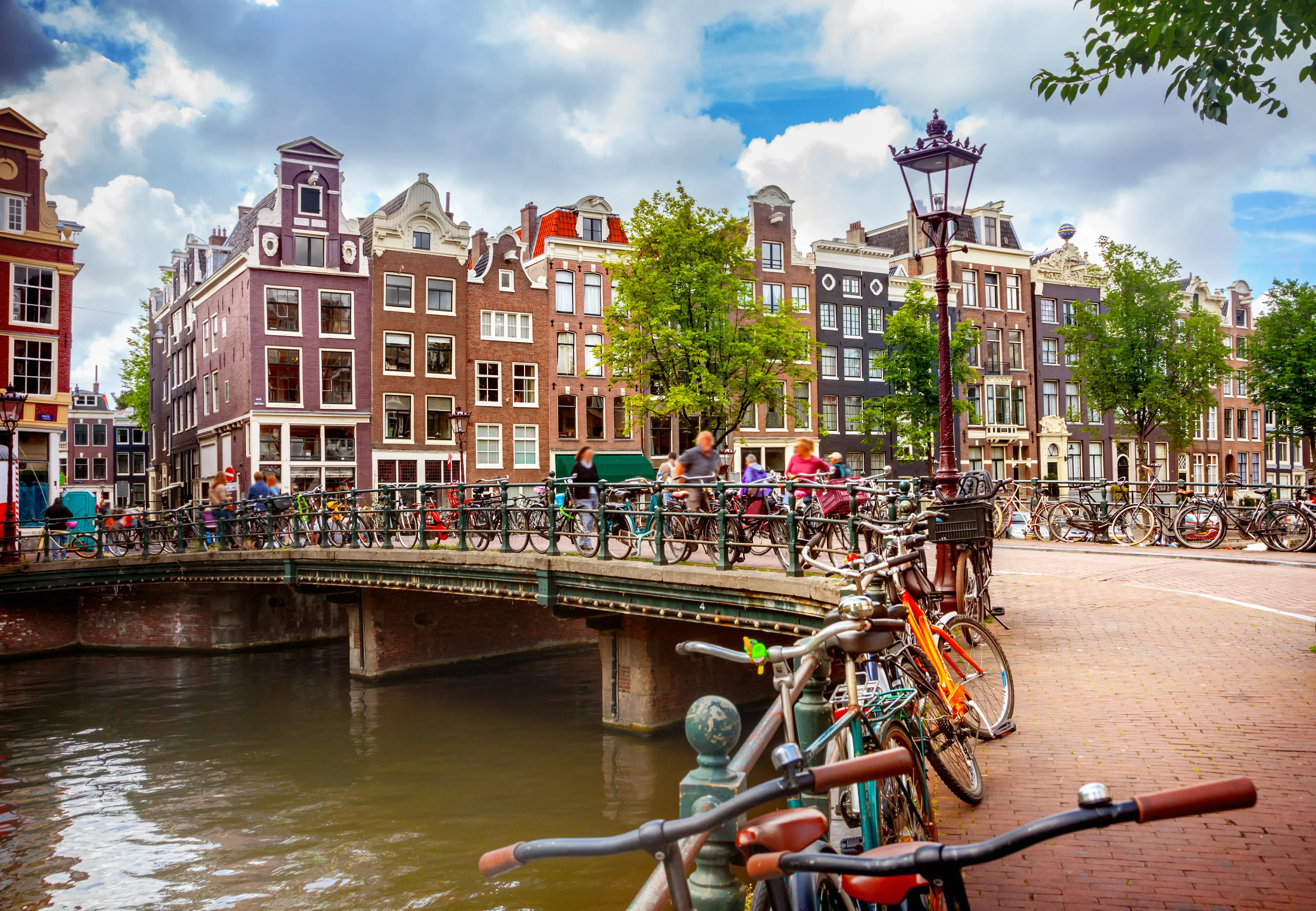canal filled with bikes in amsterdam, netherlands