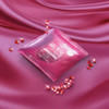 arouse her gummies on a pink sheet with glistening pomegranate seeds