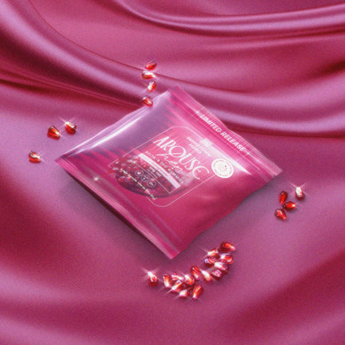 arouse her gummies on a pink sheet with glistening pomegranate seeds