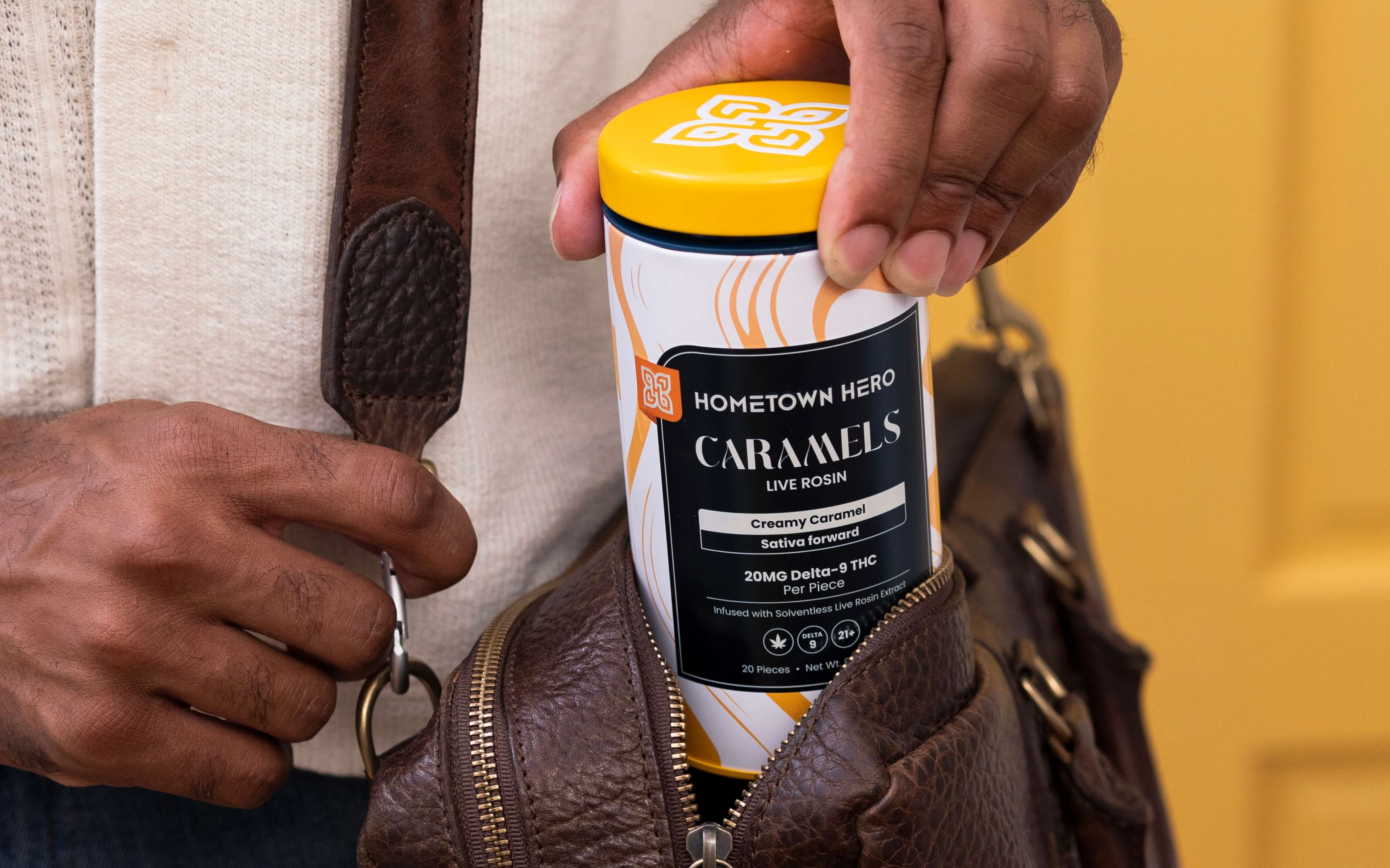 man putting tin of caramels in bag