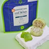 closeup of green gummies next to a prickly pear and bag