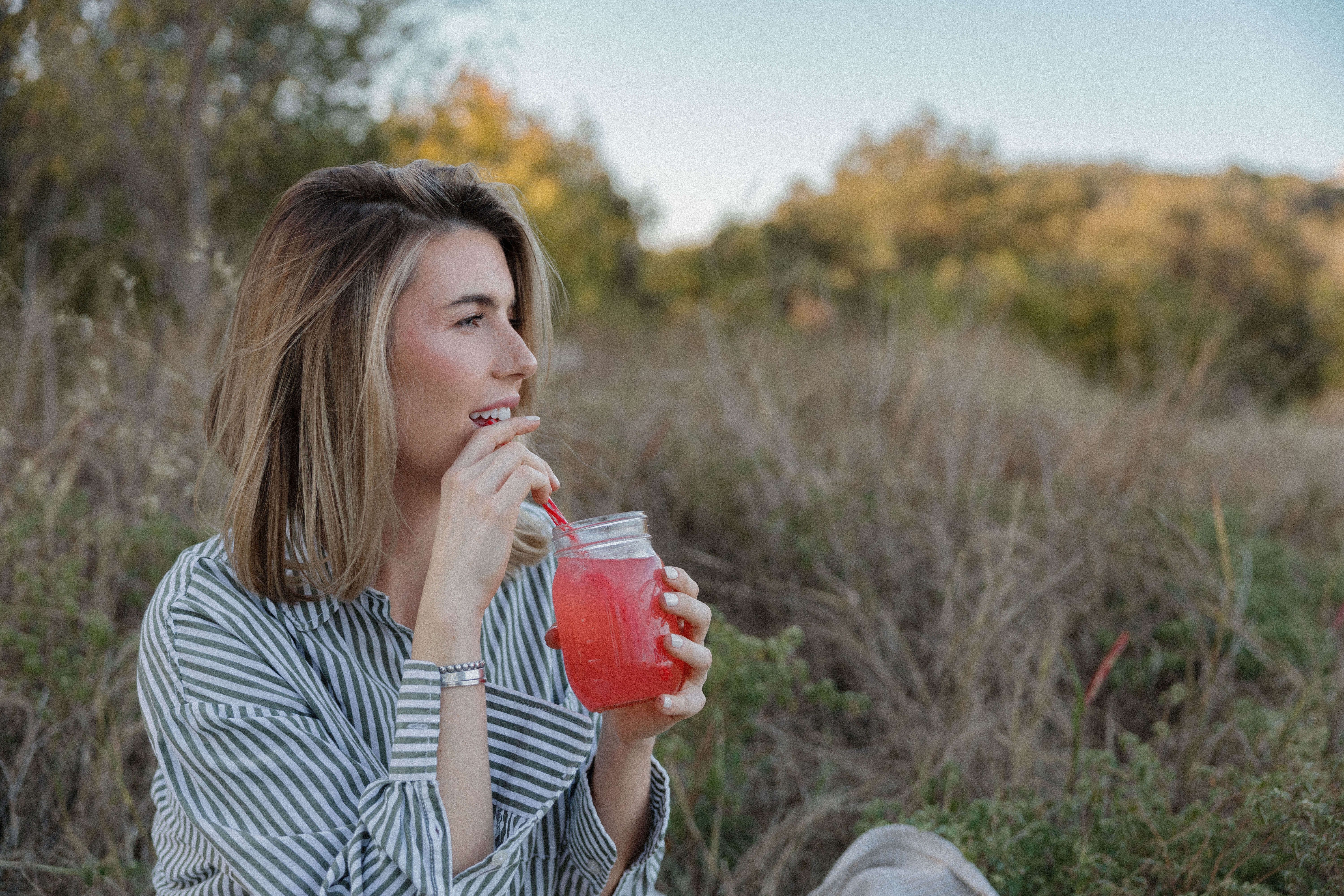woman drinking a beverage