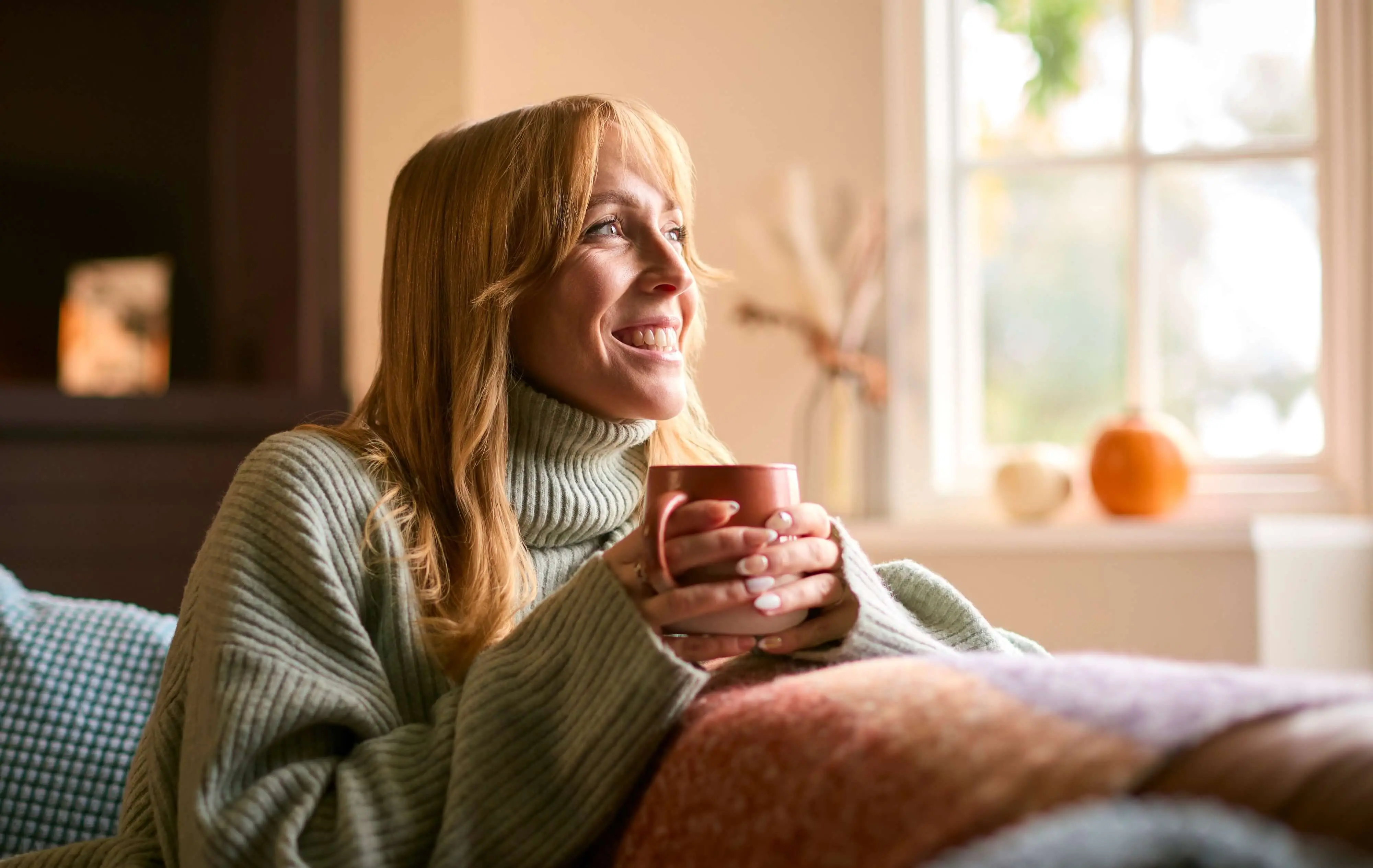 woman happily enjoying a cup of coffee