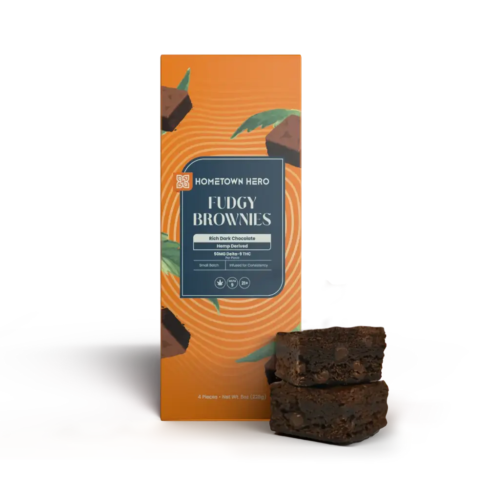 fudgy edible brownies stacked beside box