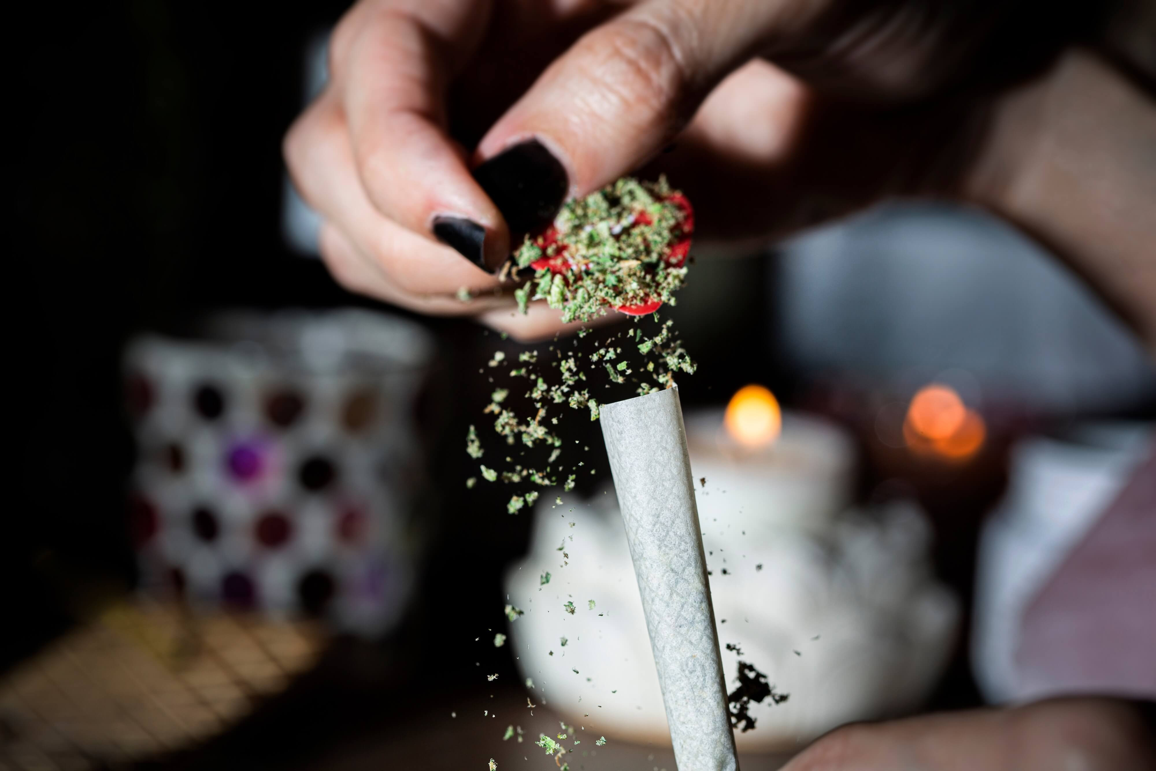 filling a cone with ground cannabis flower