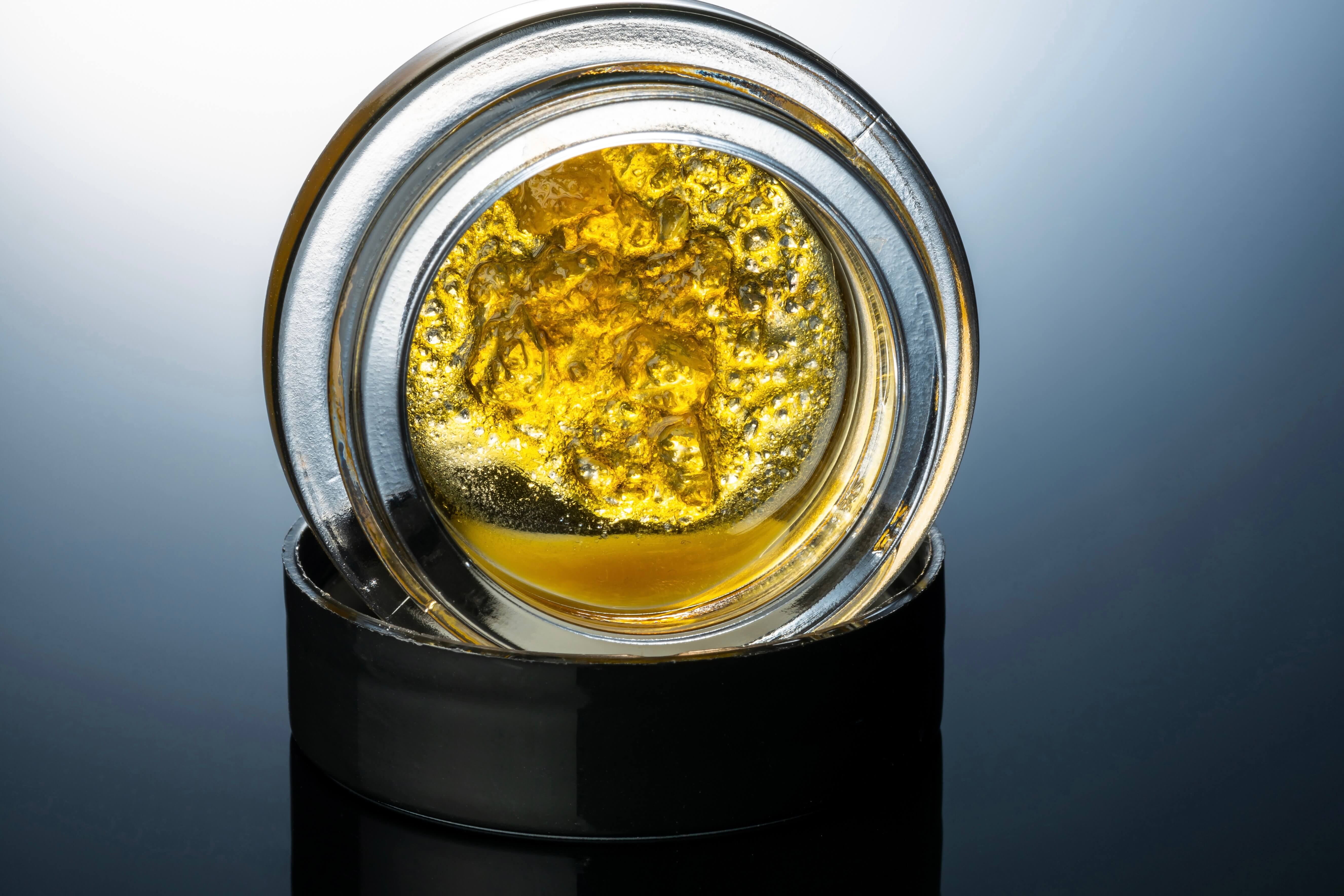 golden cannabis concentrate in a jar
