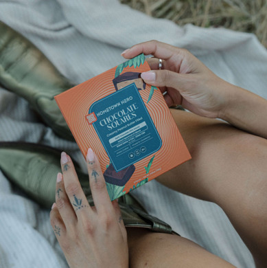 hands holding box of chocolate squares