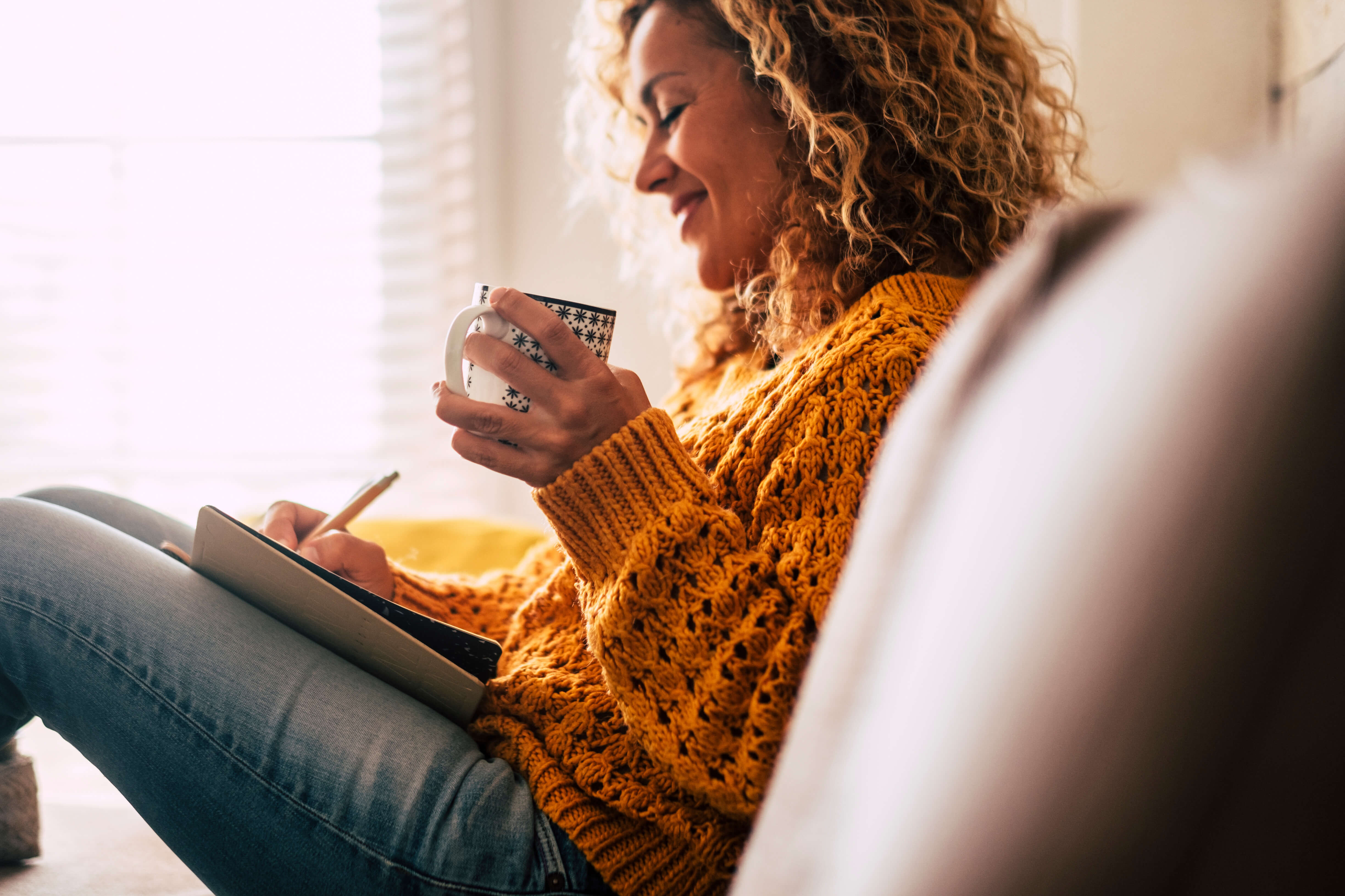 woman journaling in the morning with coffee