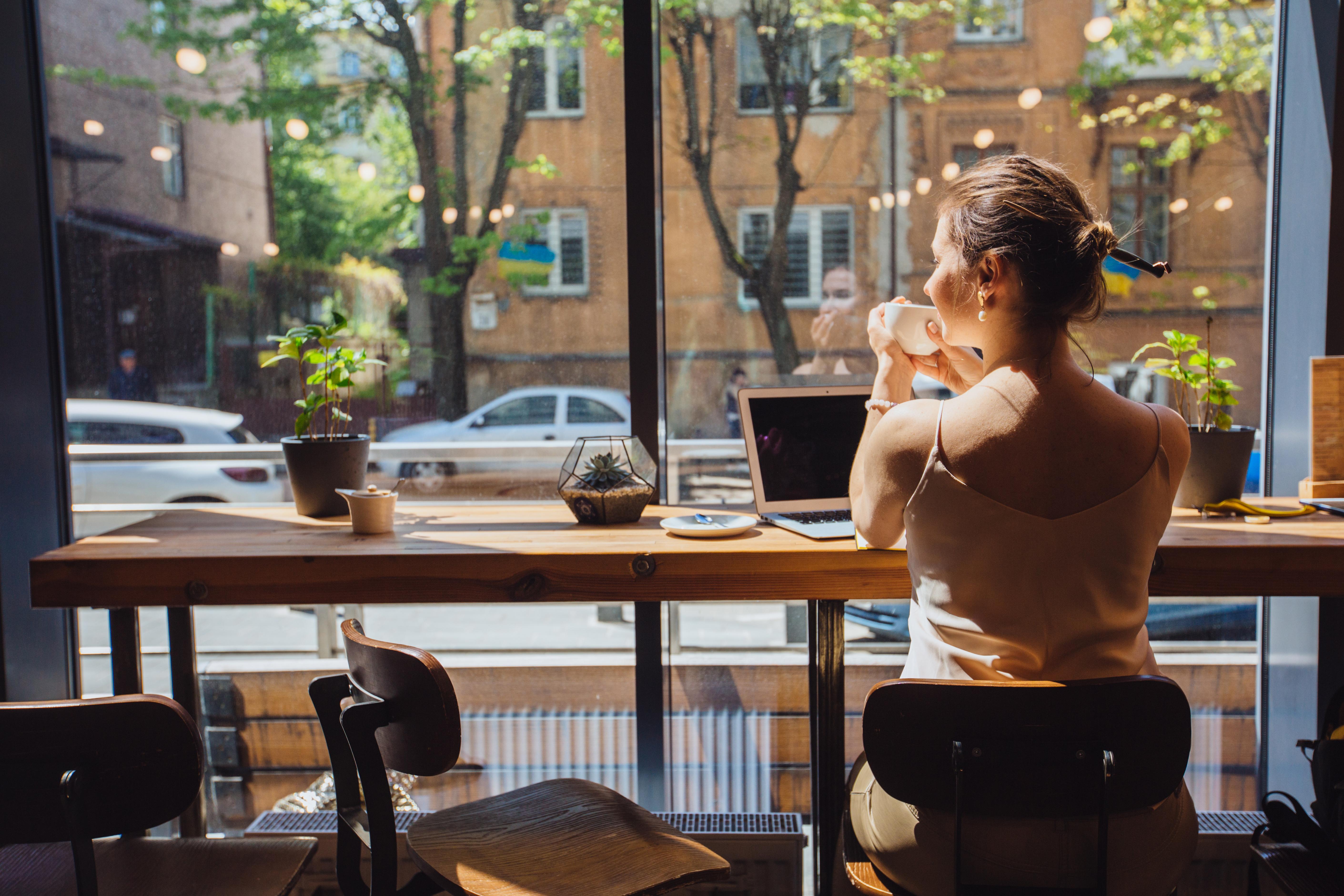 woman working on her laptop in a coffee shop
