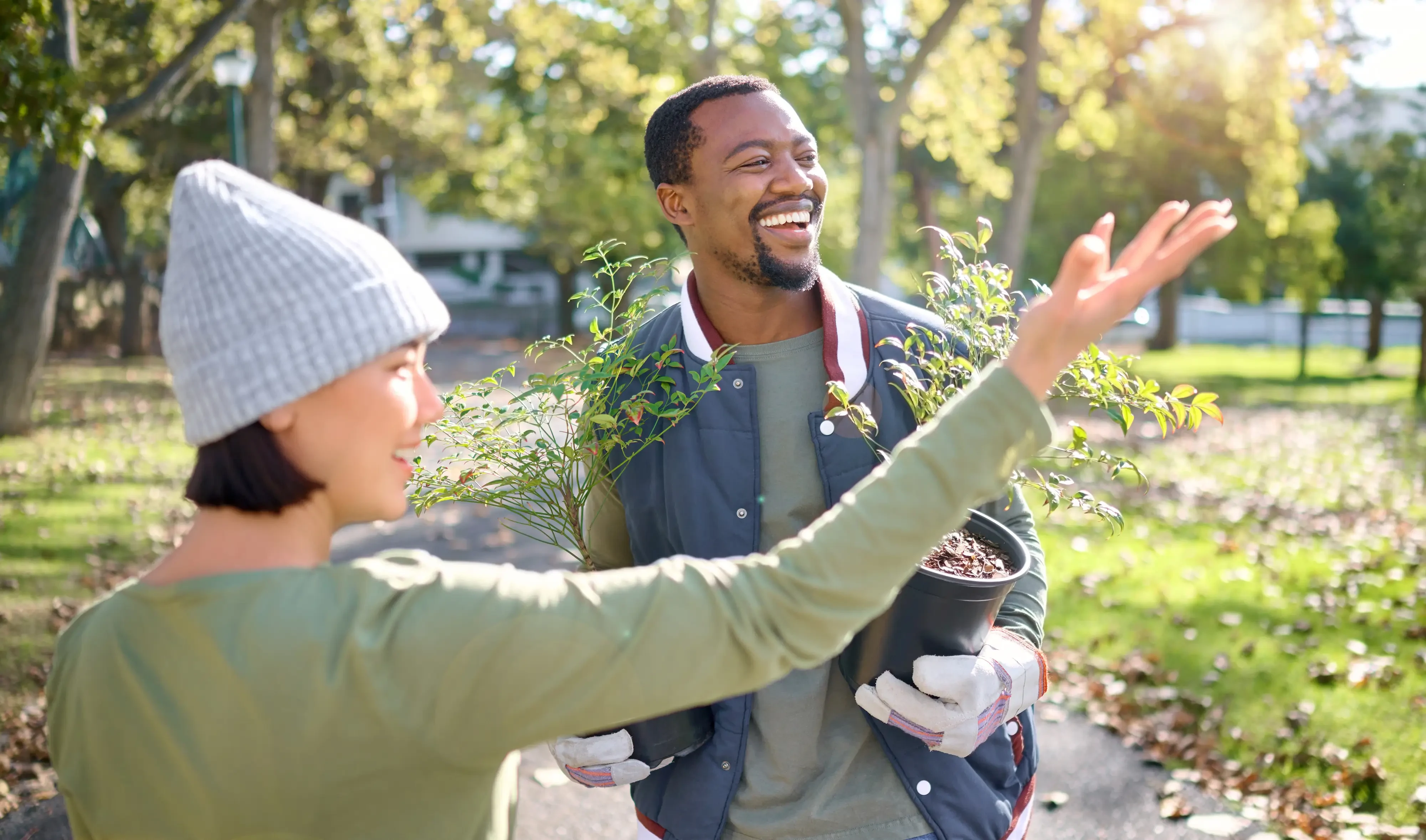 man and woman smiling in a community garden