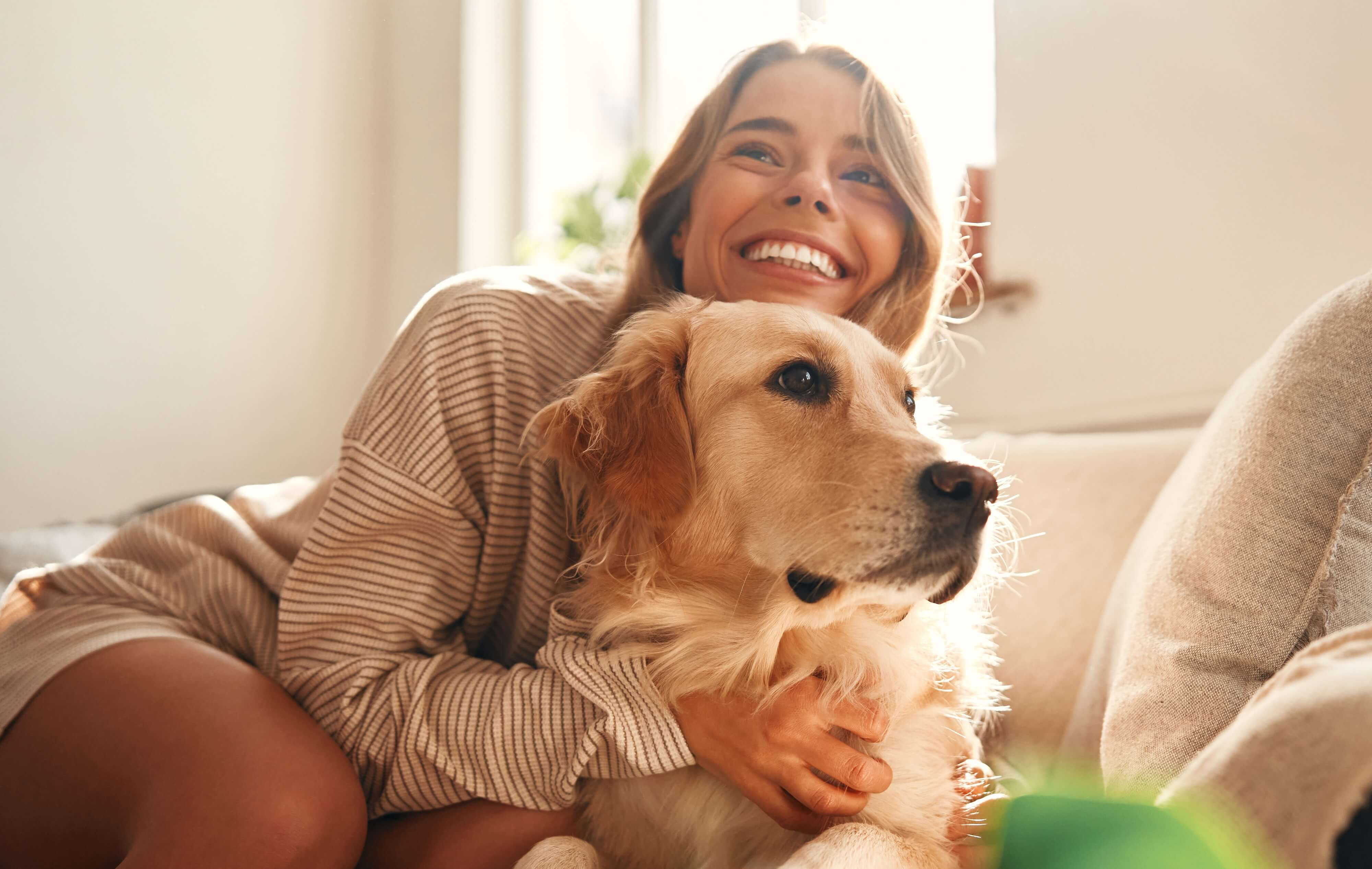 woman smiling happily with dog