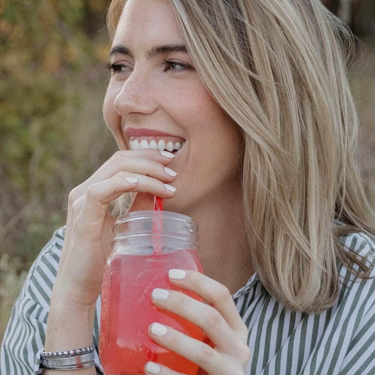 smiling while drinking drink