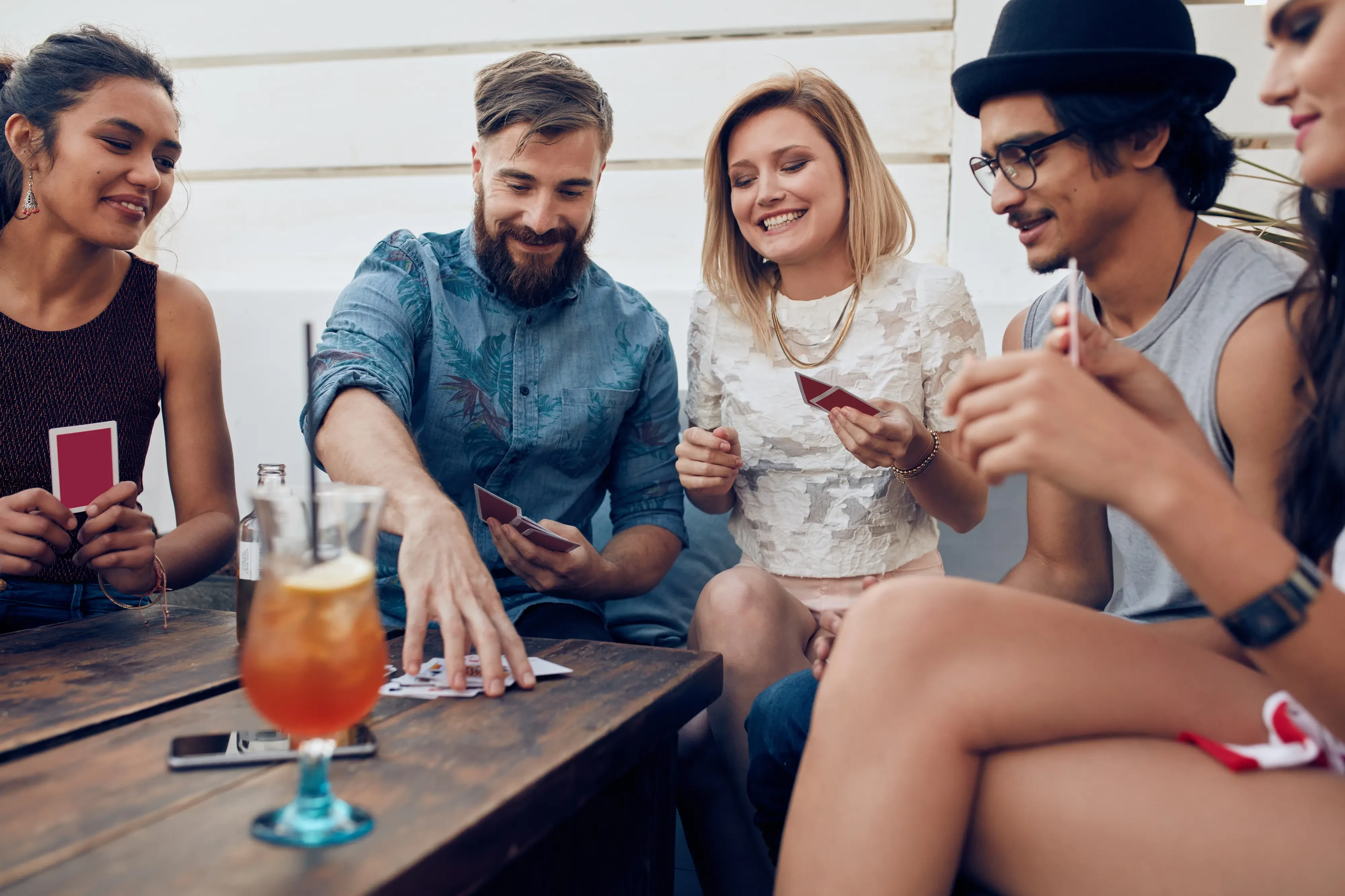 group of young adults playing card games