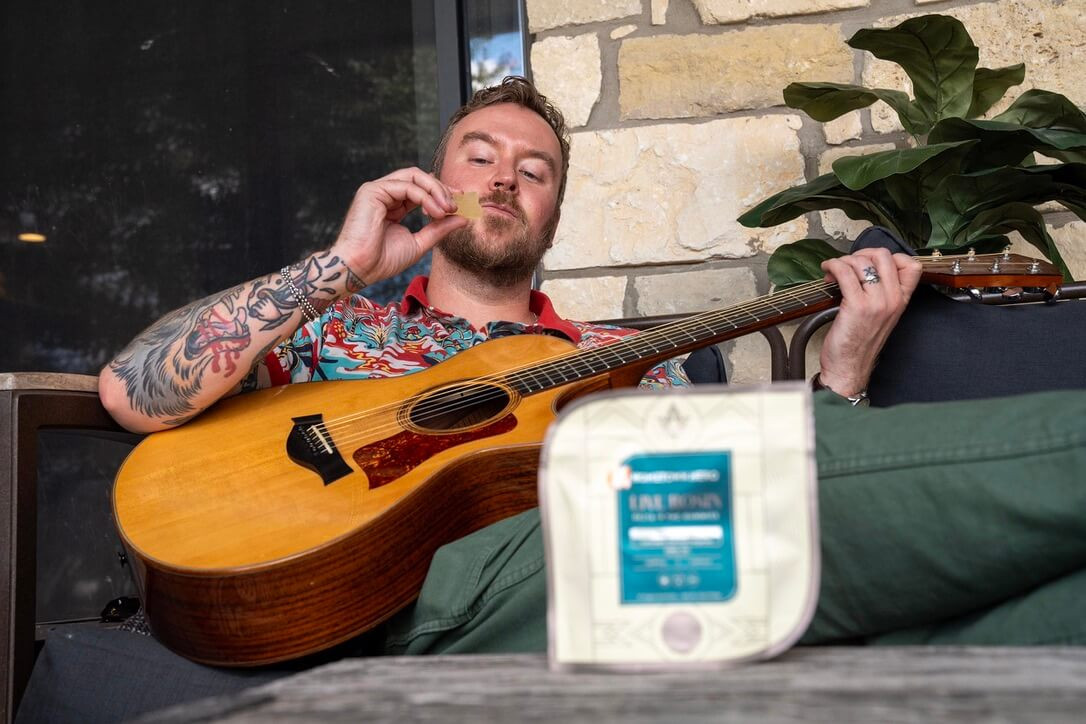 man holding a thc gummy
