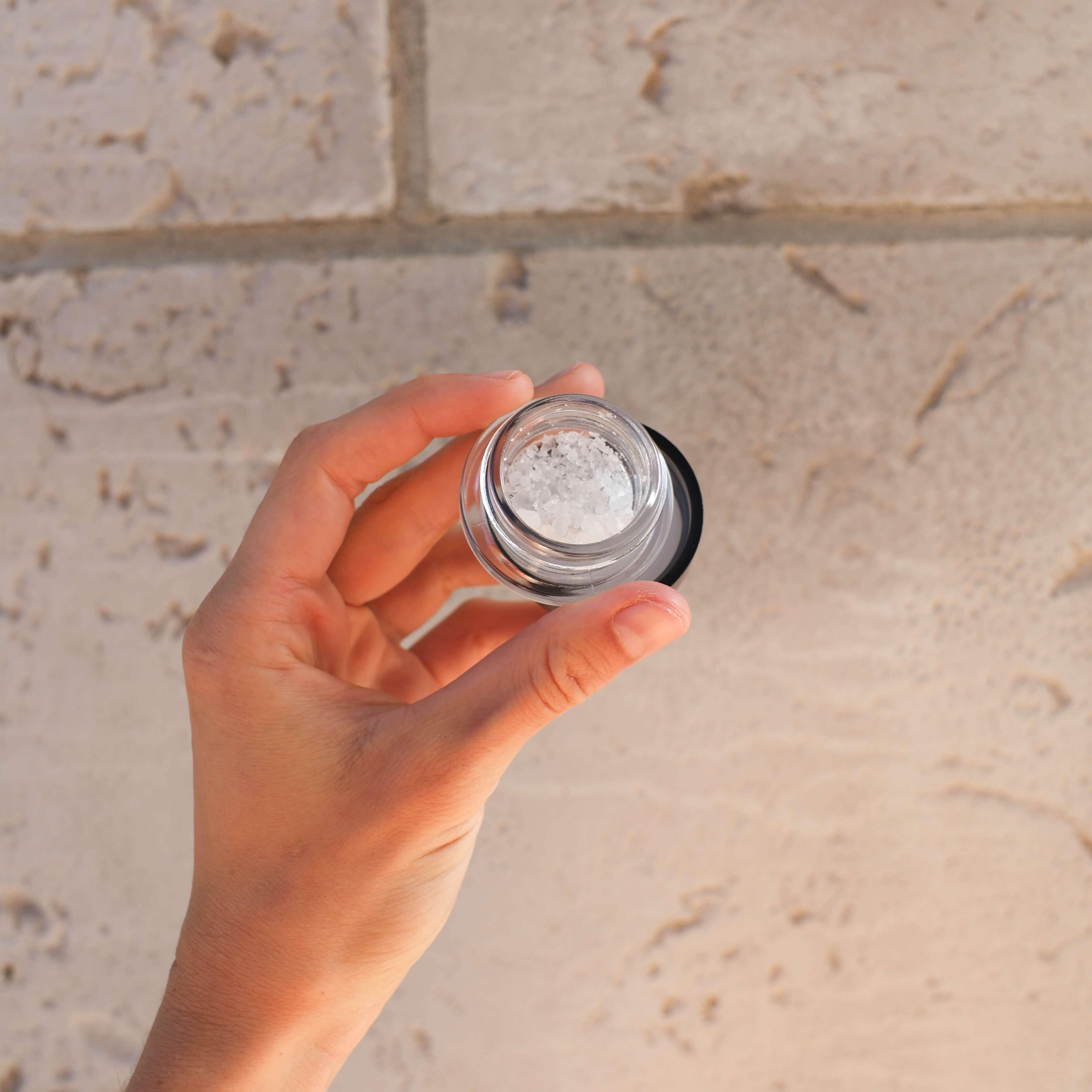 hand holding jar of diamonds