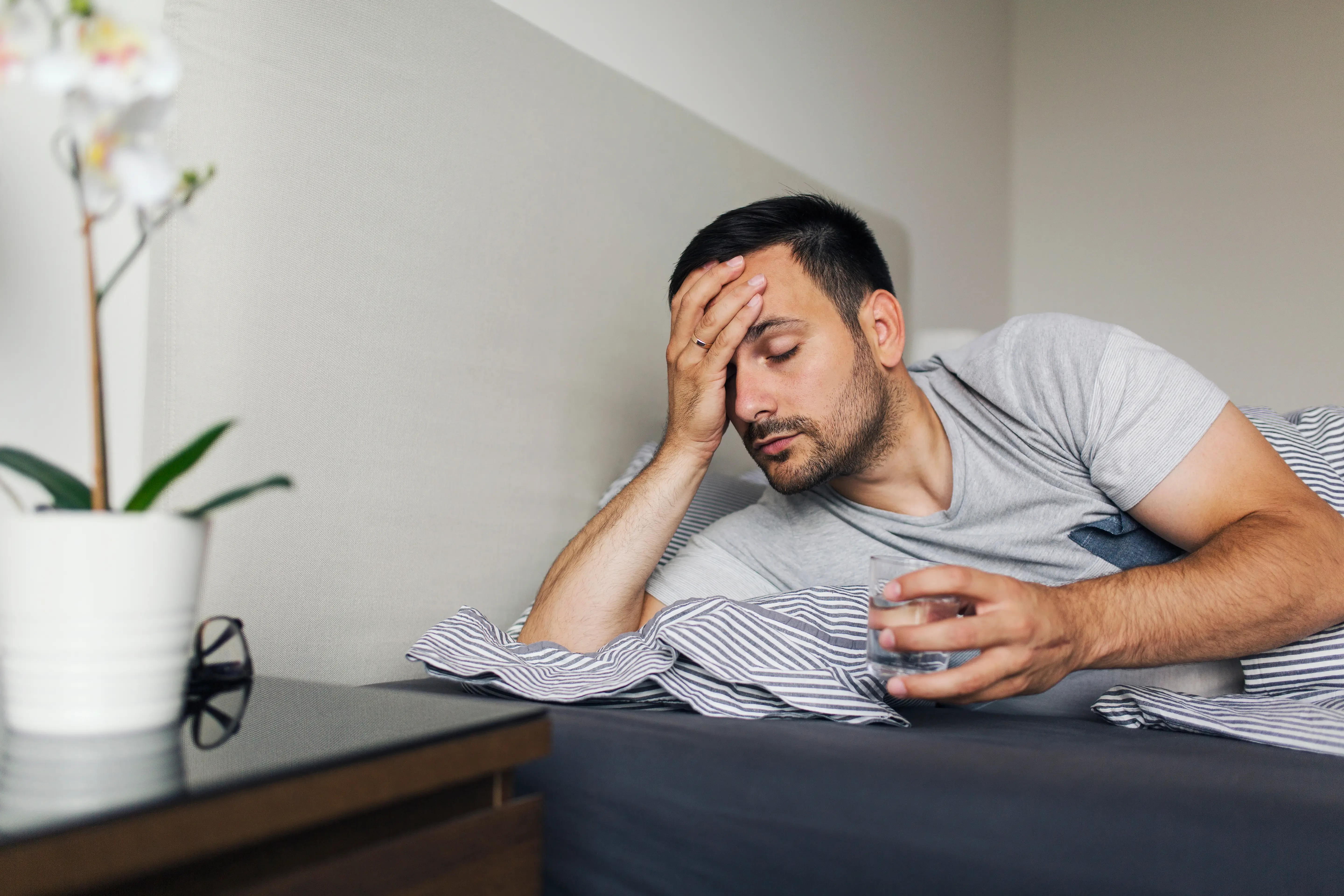 man wakes up to a hangover