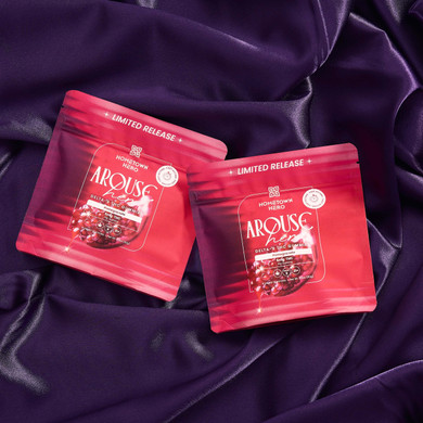 two pink bags of gummies on purple sheets