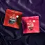 two bags of gummies on silk sheets
