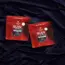 two red bags of gummies on purple sheets
