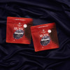 two red bags of gummies on purple sheets