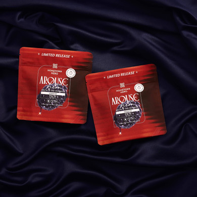 two red bags of gummies on purple sheets