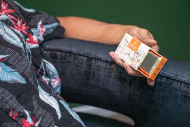 man holding kava + thc chocolate bar