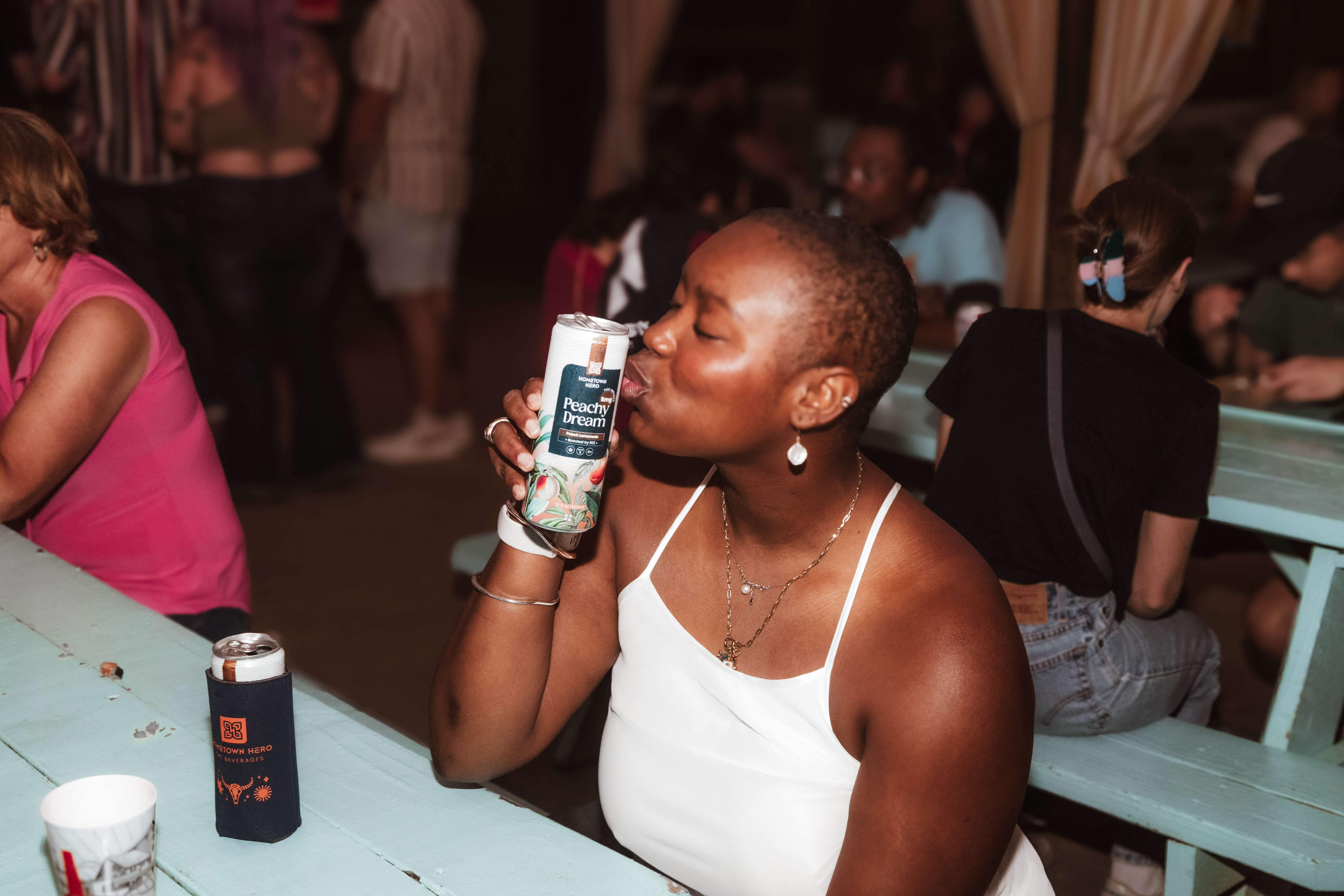 woman holding can of thc seltzer and kissing it