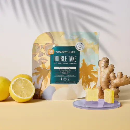 shadow of a palm tree over nag of gummies next to ginger root and lemons