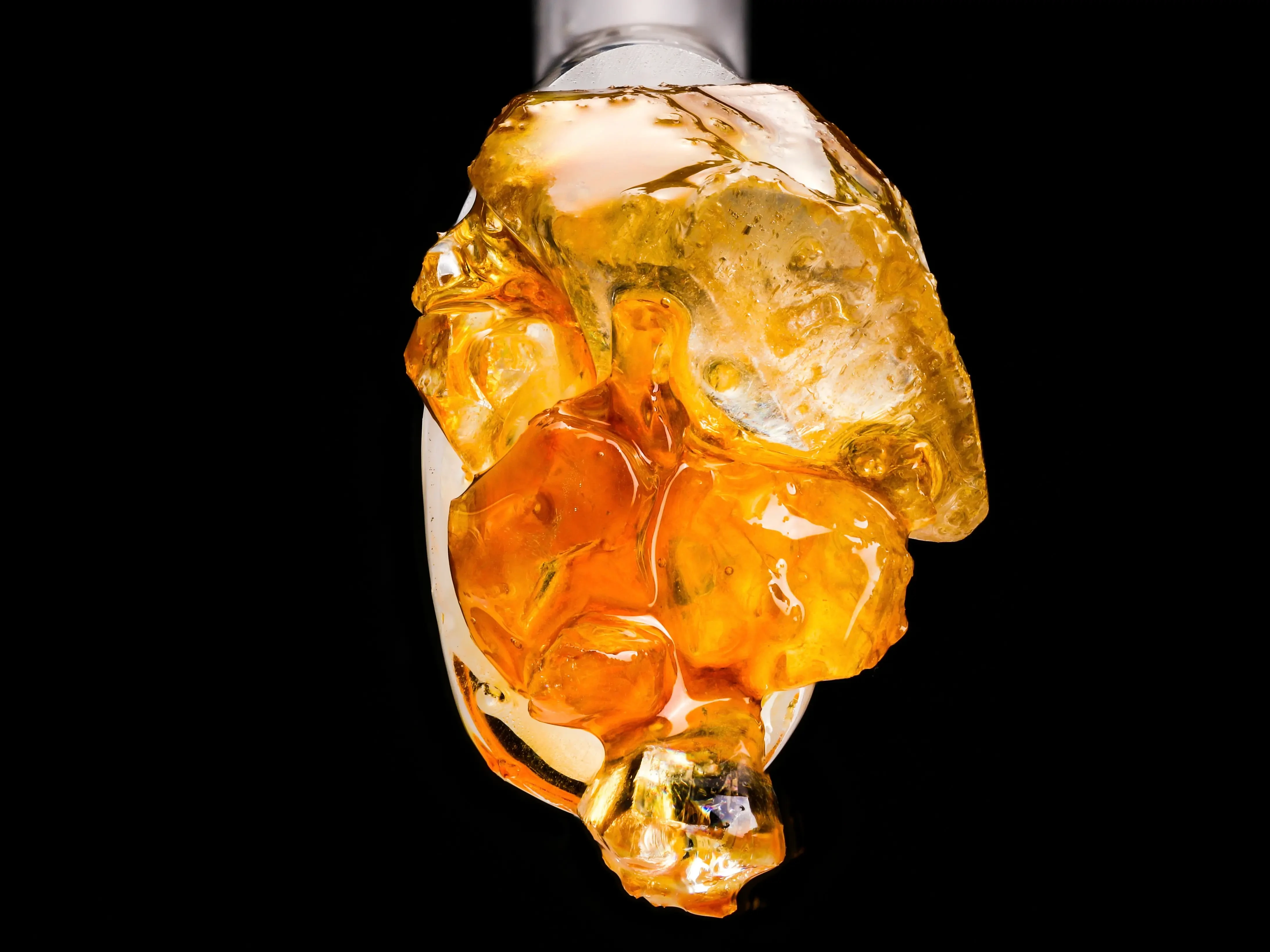 Gold and Amber colored Cannabis Diamonds on a Glass Dab Tool