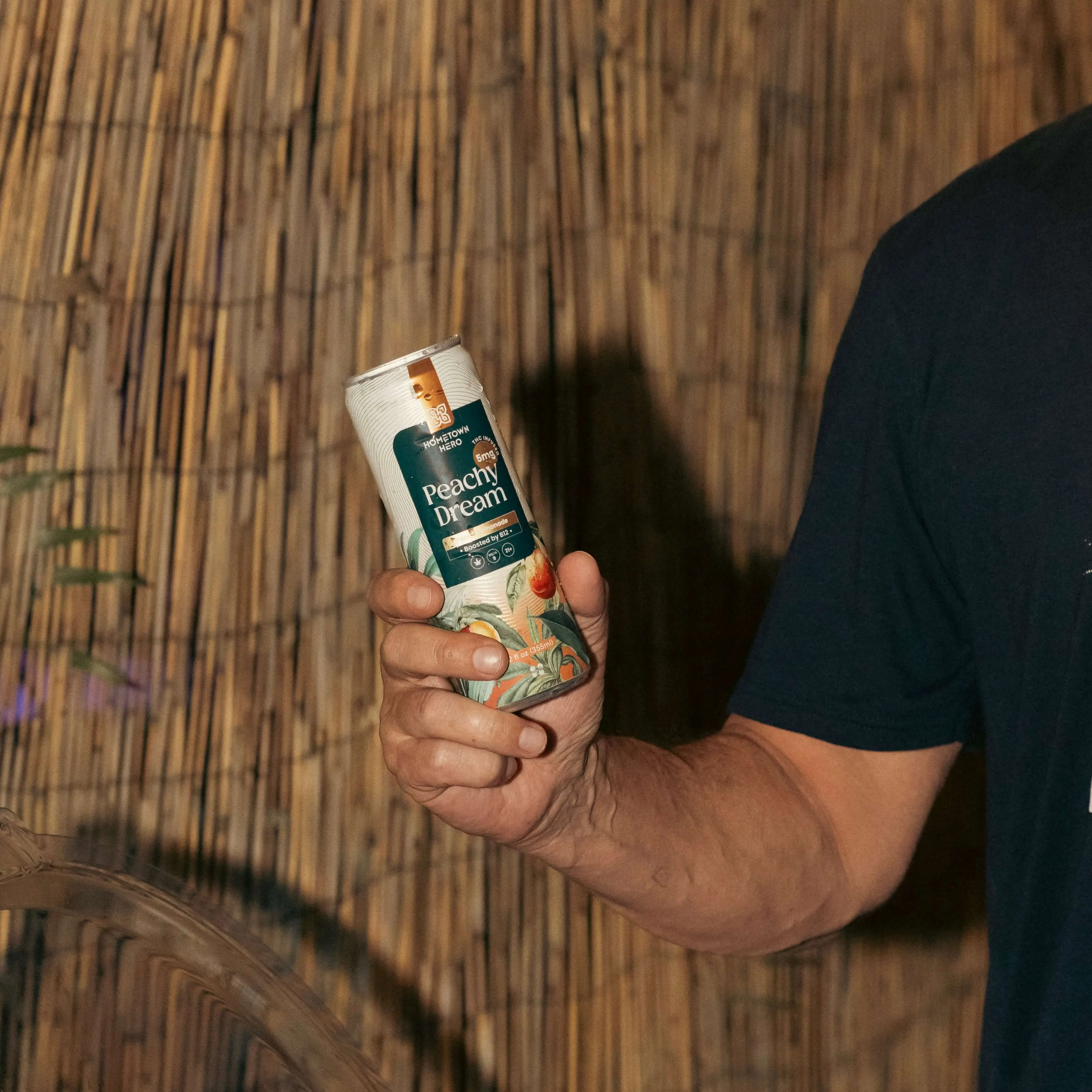 man holding can of THC infused lemonade