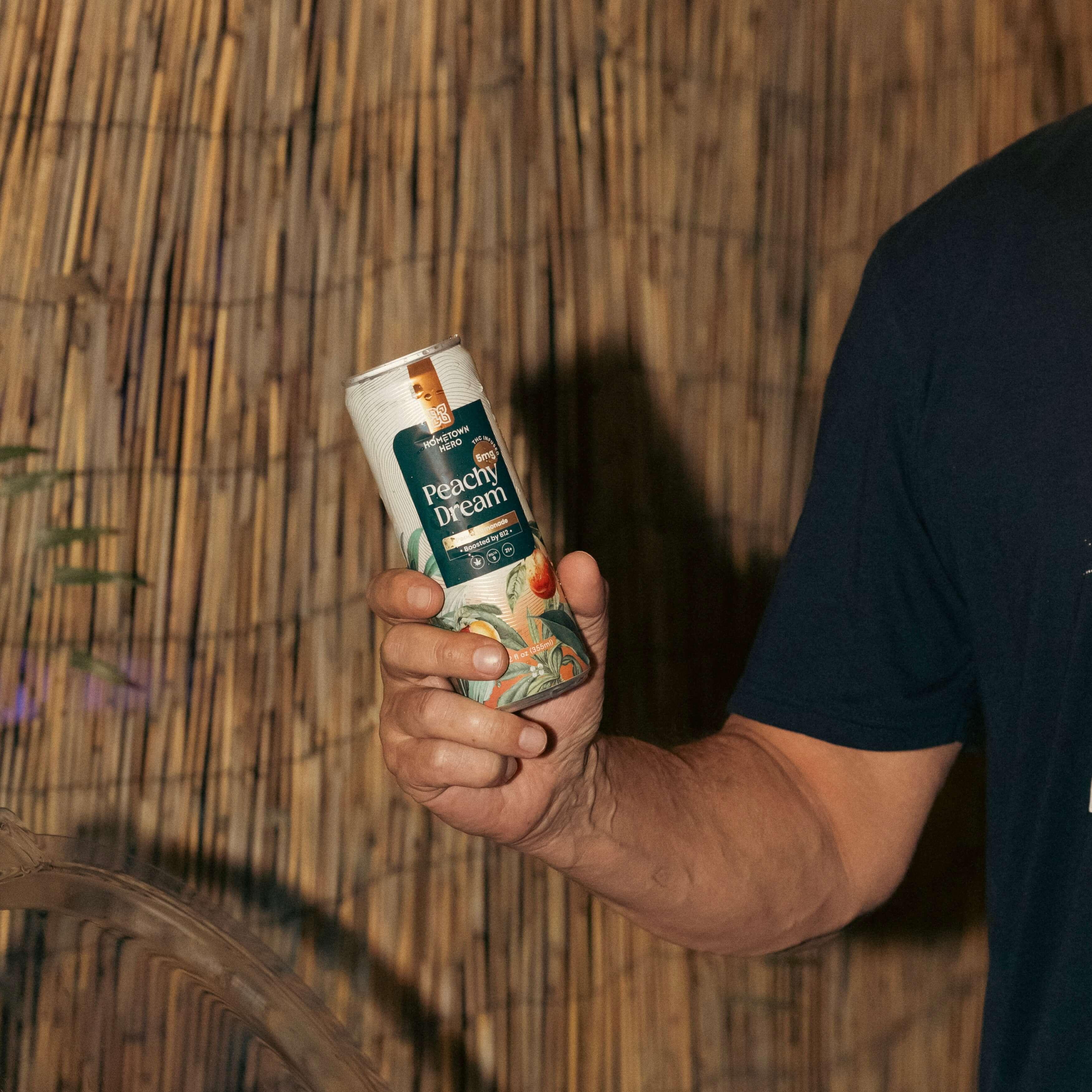 man holding can of THC infused lemonade
