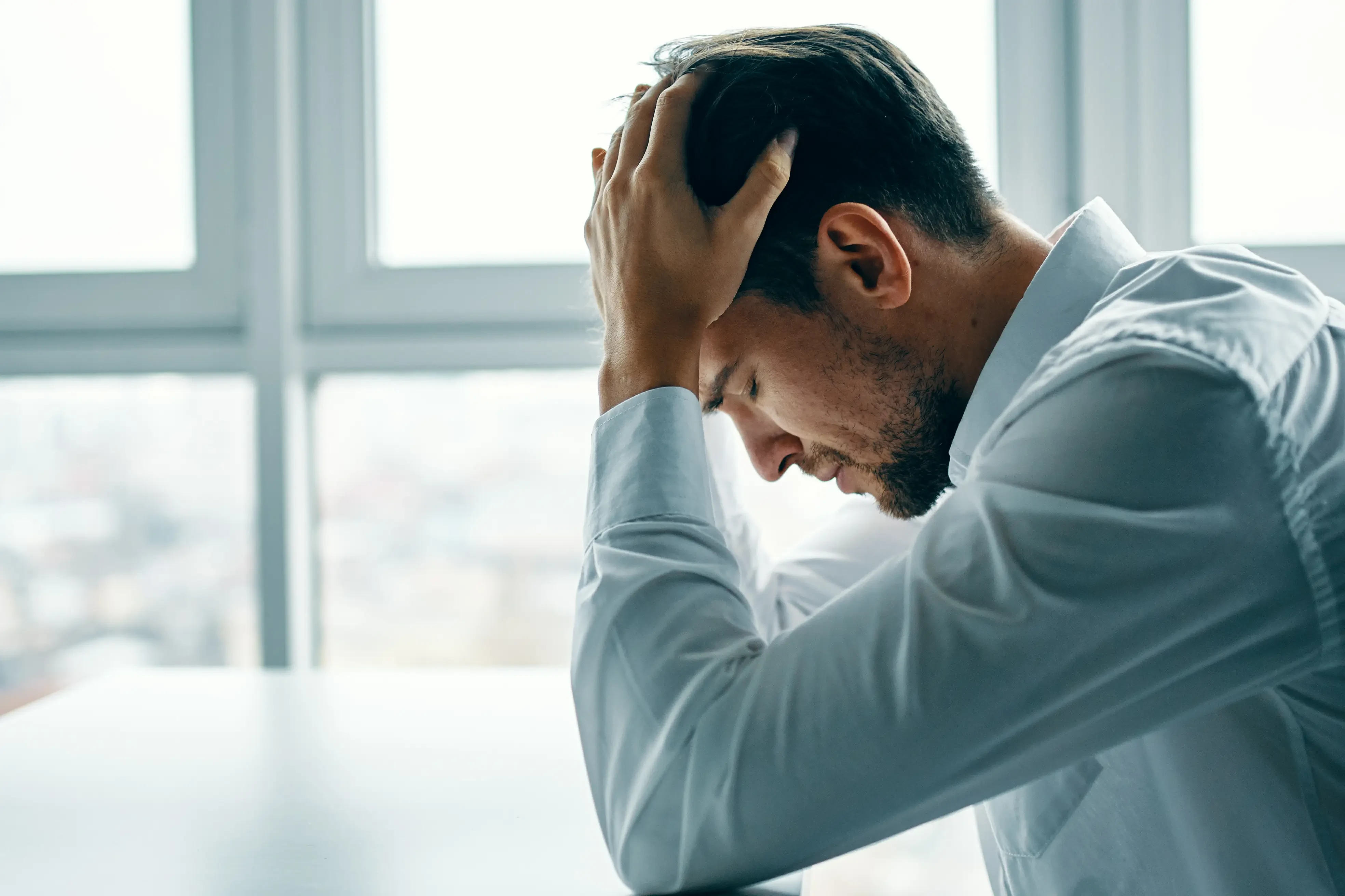 man suffering from migraines