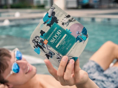 young man holding a bag of gummies