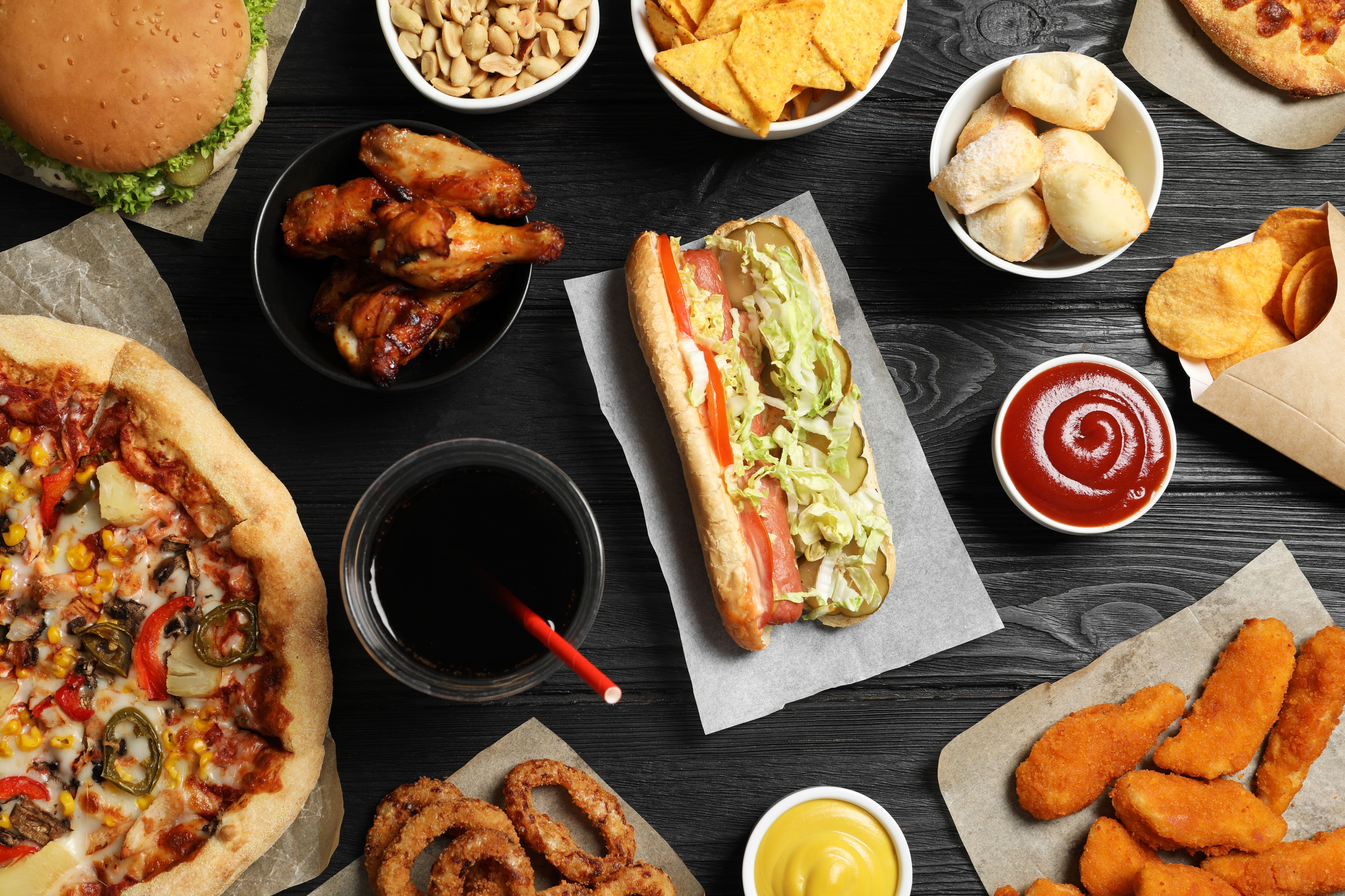 table with an assortment of salty snacks and fast food