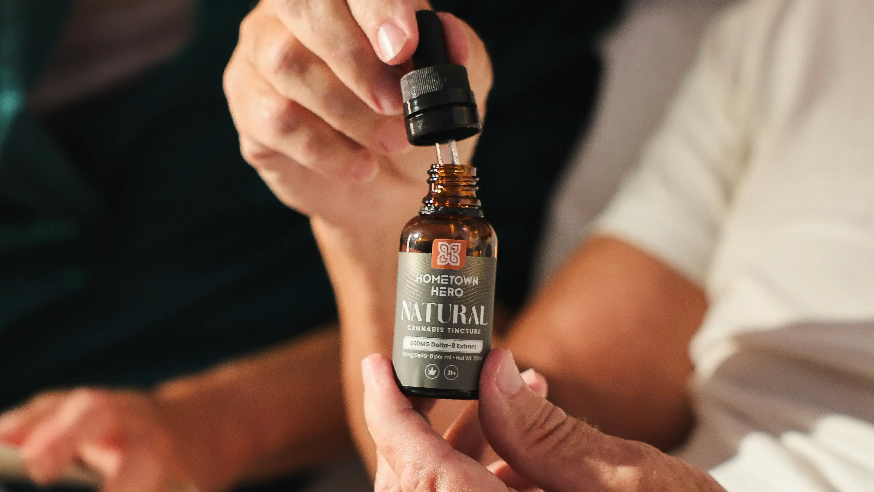 holding a natural cannabis tincture