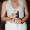 woman holding peachy dream can