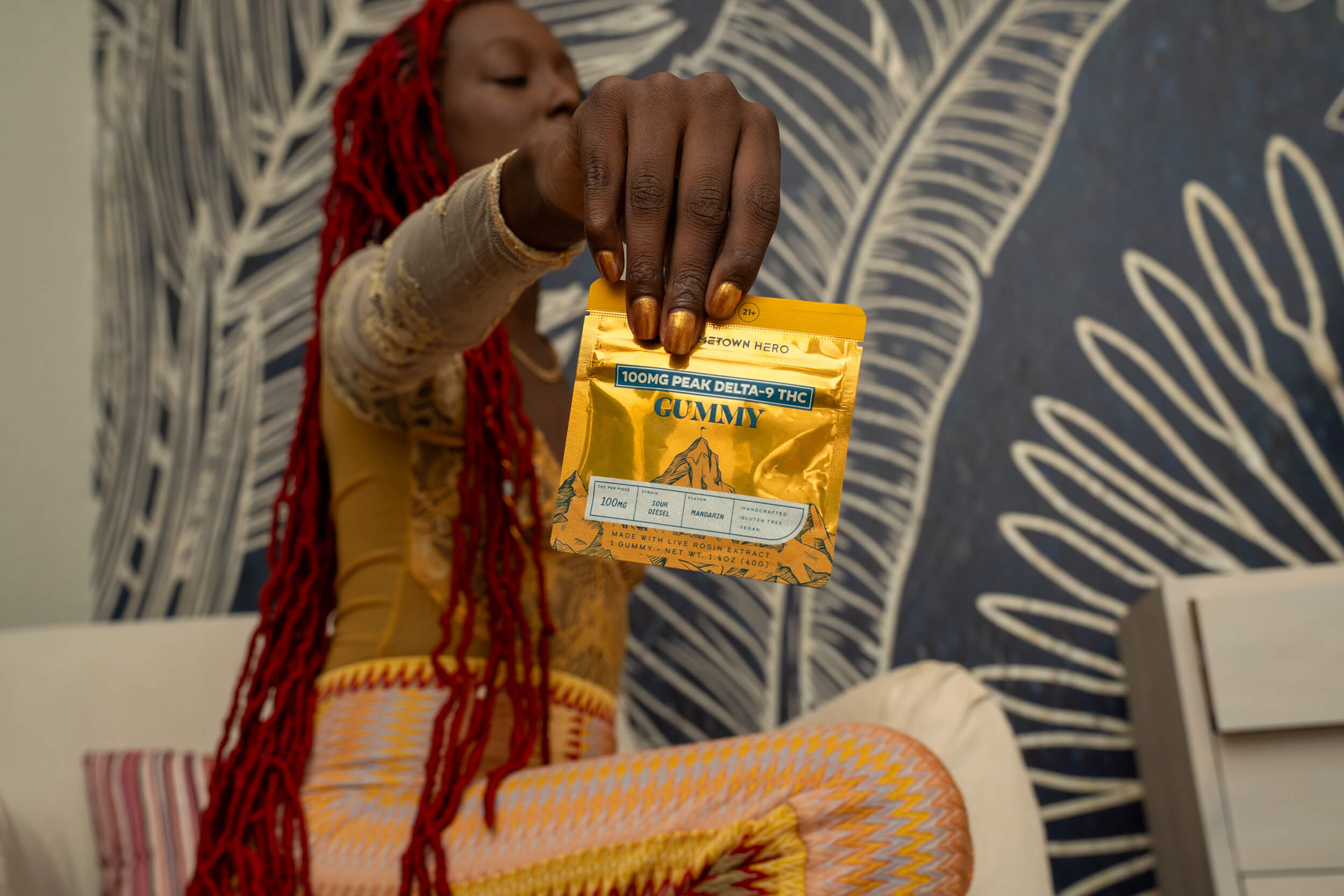 woman holding peak gummy to camera