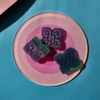 sugary purple green edibles on a plate