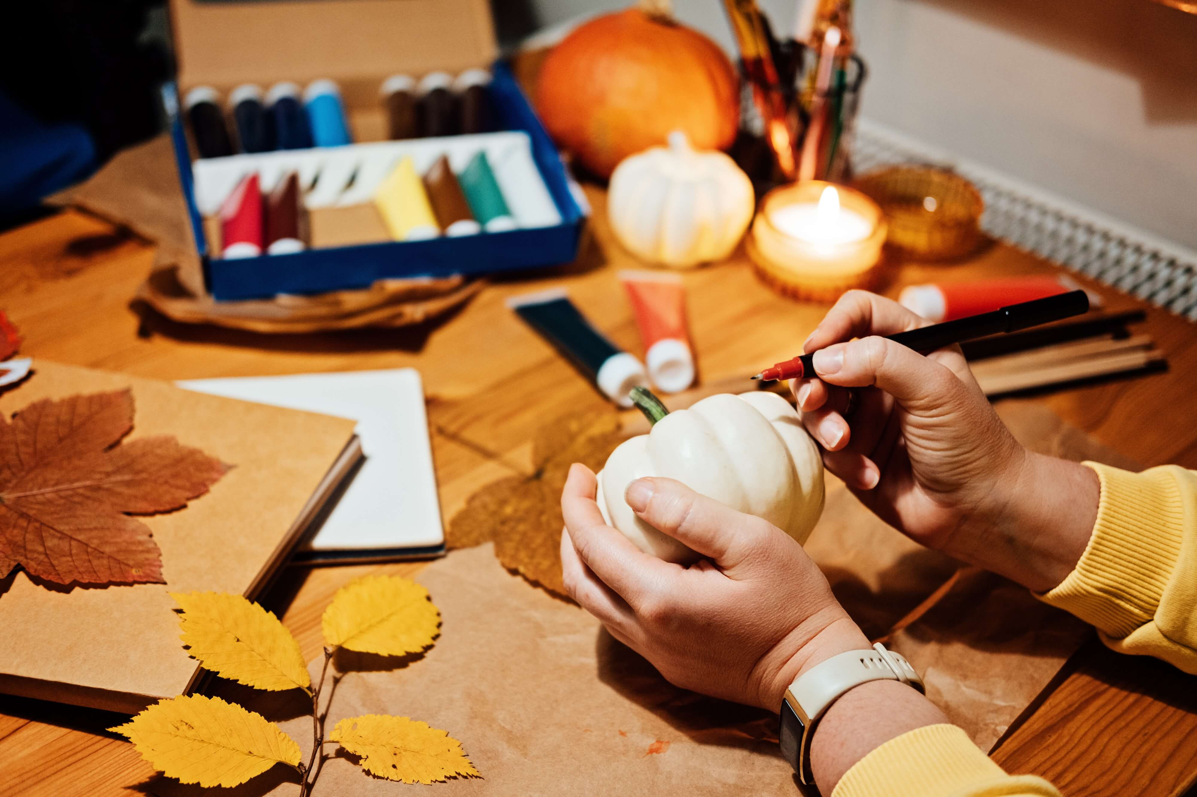 woman painting a pumpkin