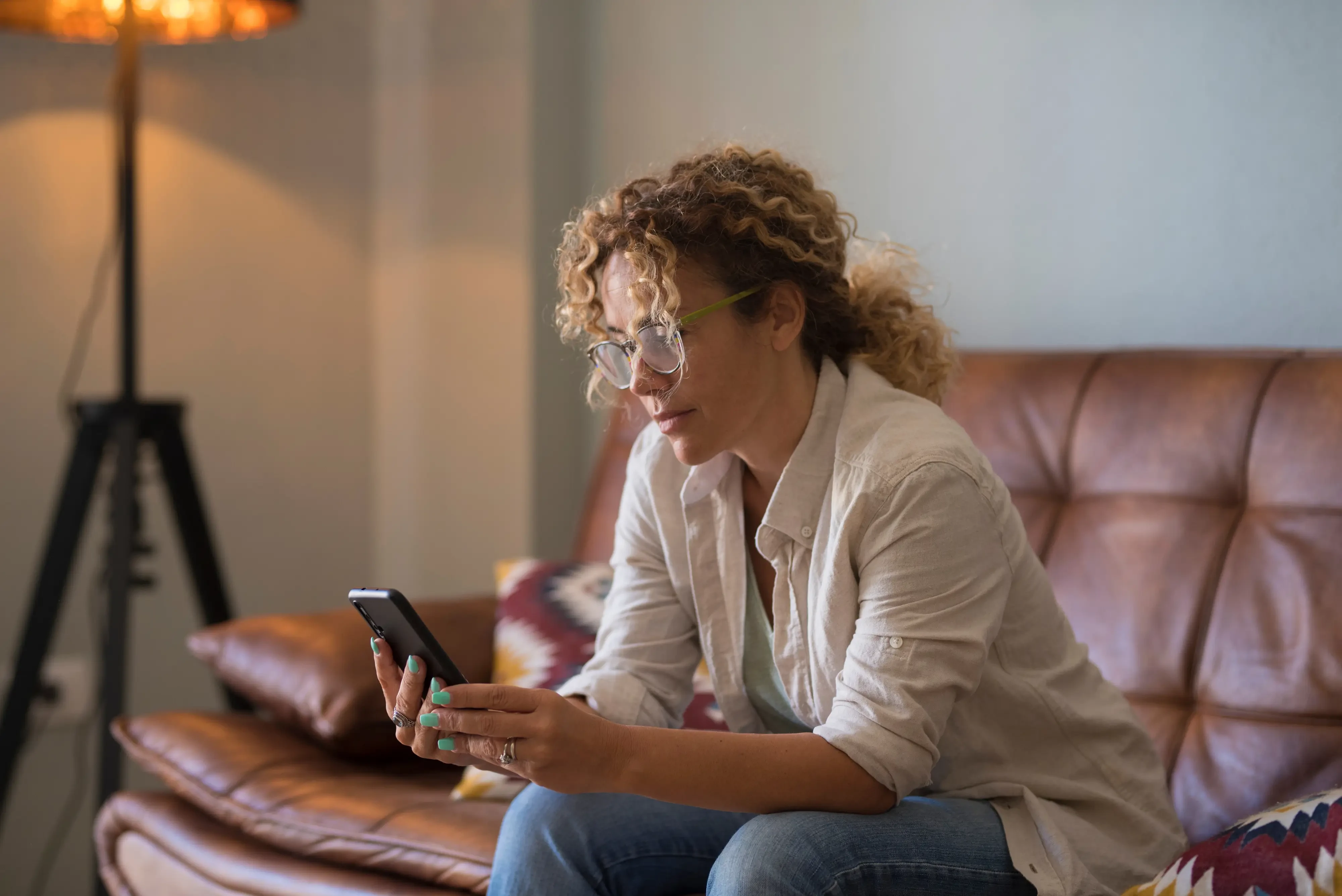 woman reading a document intently on her cellphone