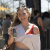 woman happily holding can of ruby oasis lemonade