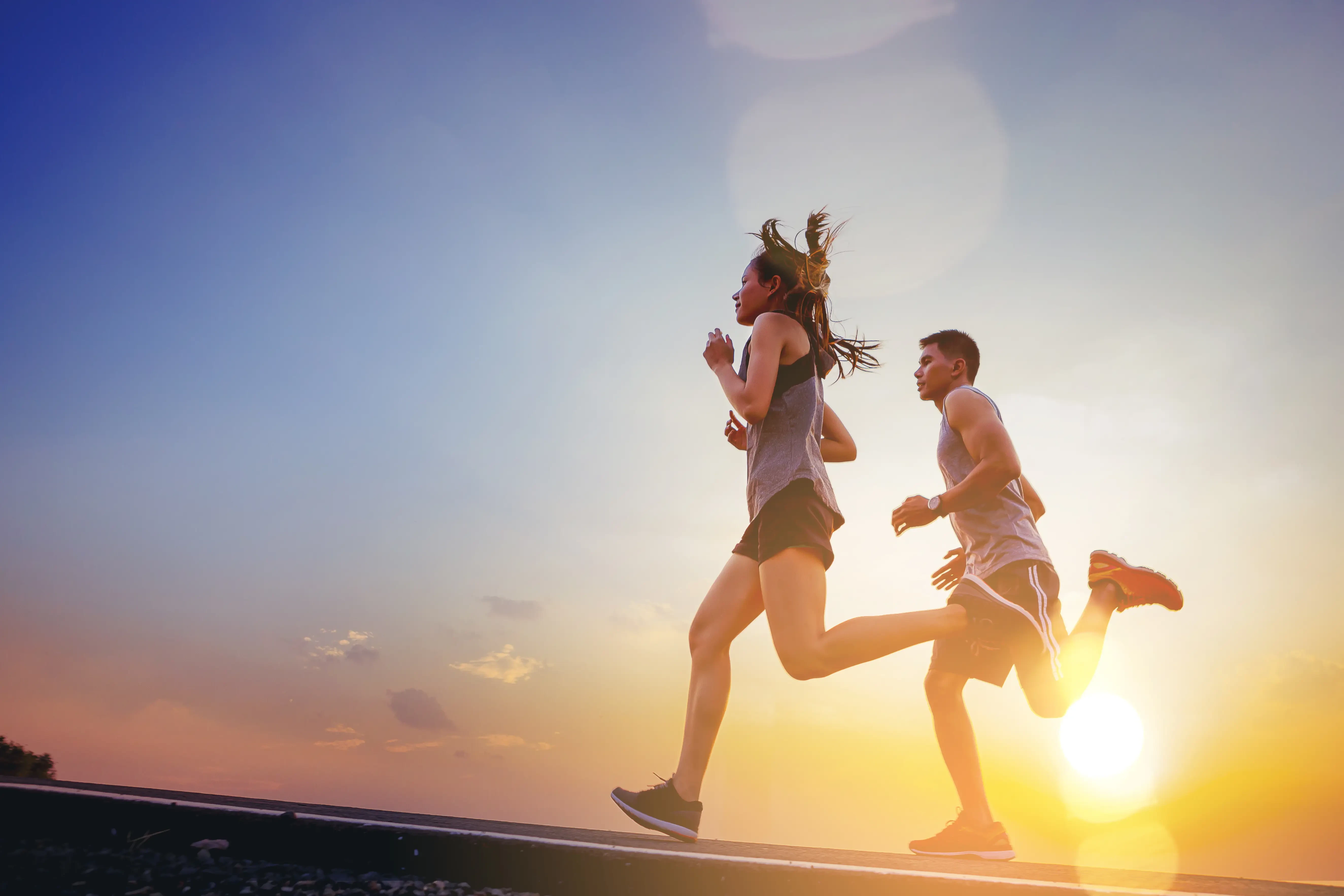 two runners running at sunset