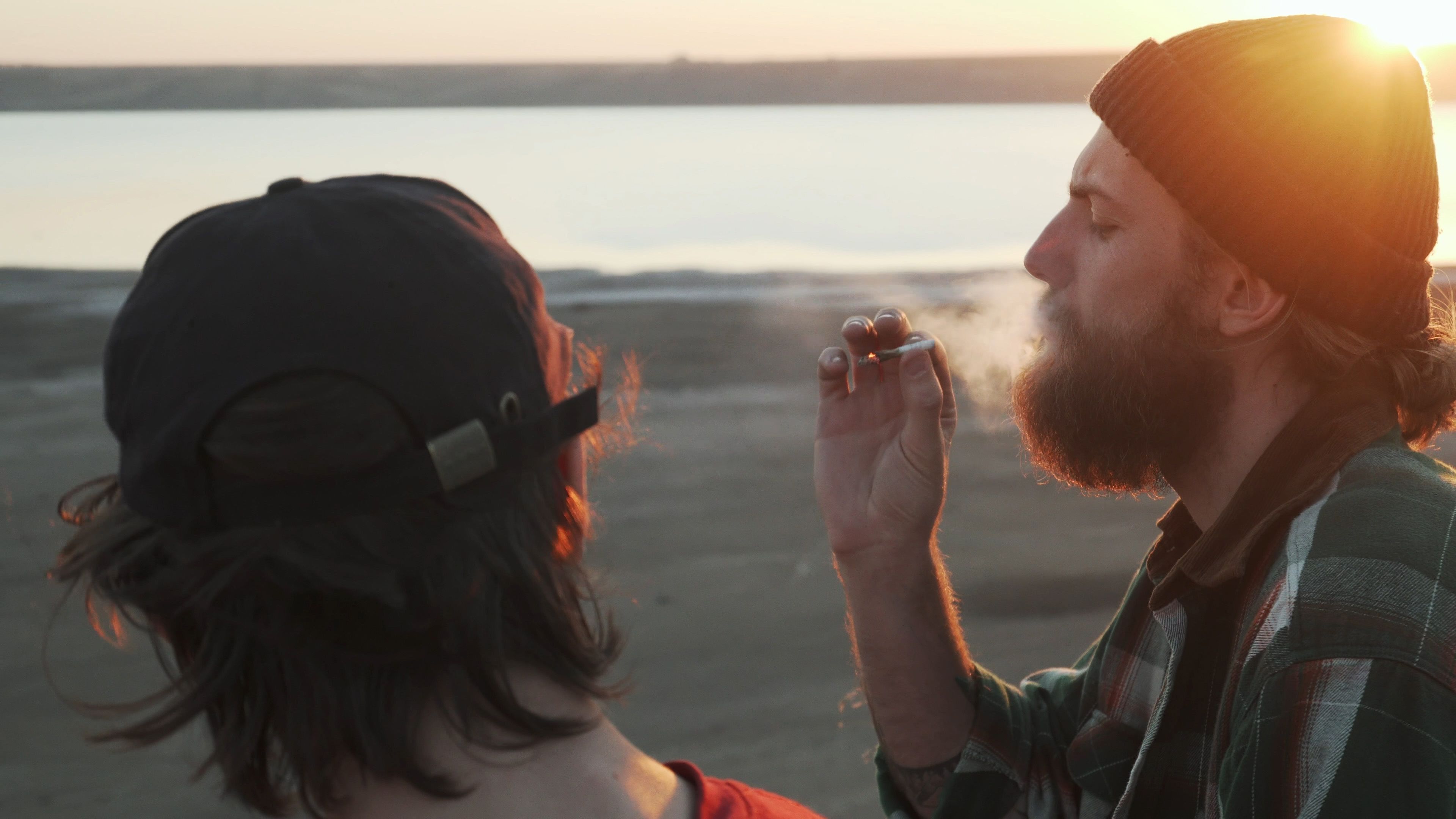 friends smoking cannabis at the beach