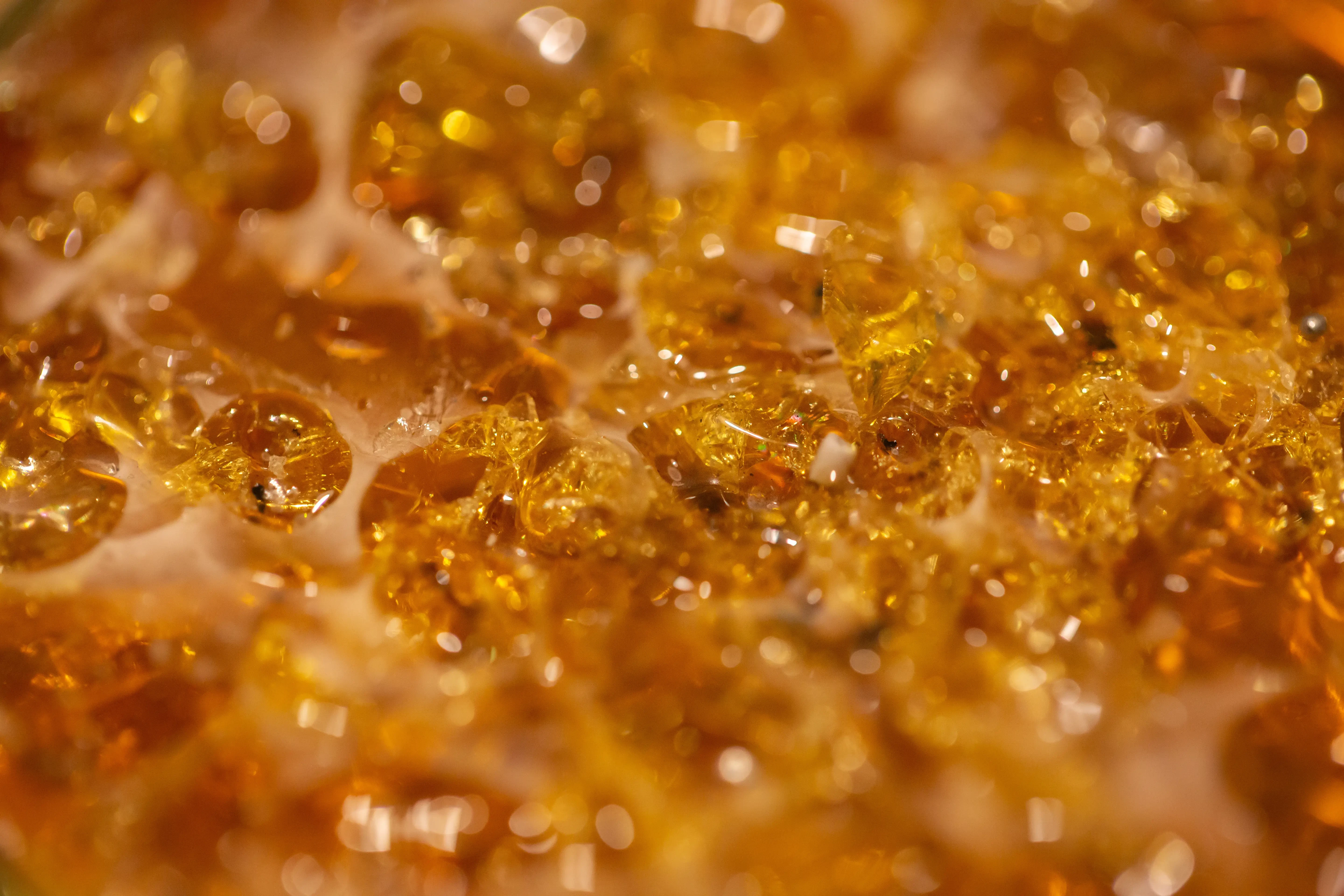 live rosin, a concentrate derived from the solvetless extraction process. golden hue and semi liquid